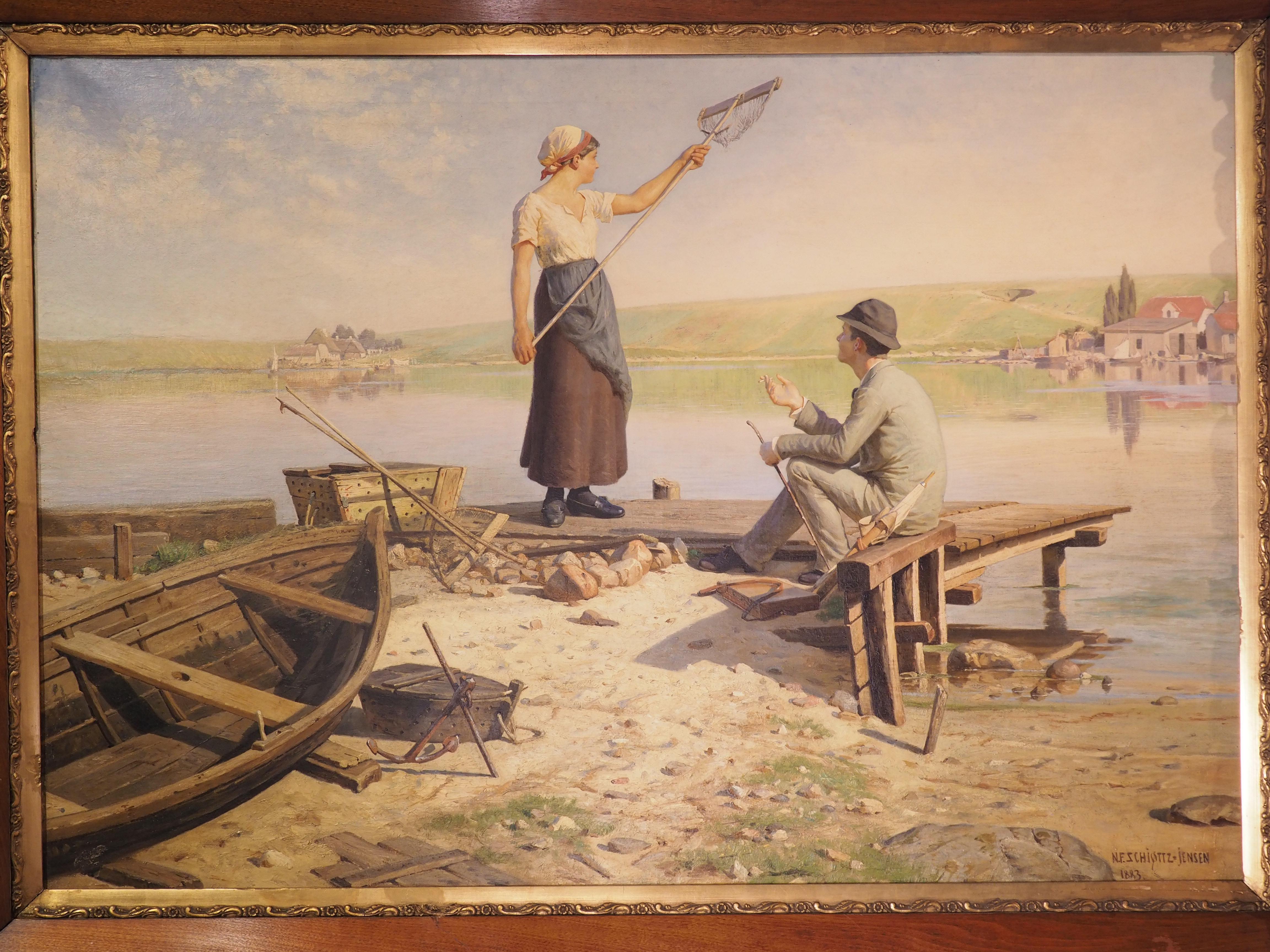 This large oil on canvas painting from Denmark depicts a woman and a man on the shore of a serene body of water. The painting is signed in the lower right corner “N. F. Schiottz-Jensen 1883” and is surrounded by a frame adorned with foliate motifs.
