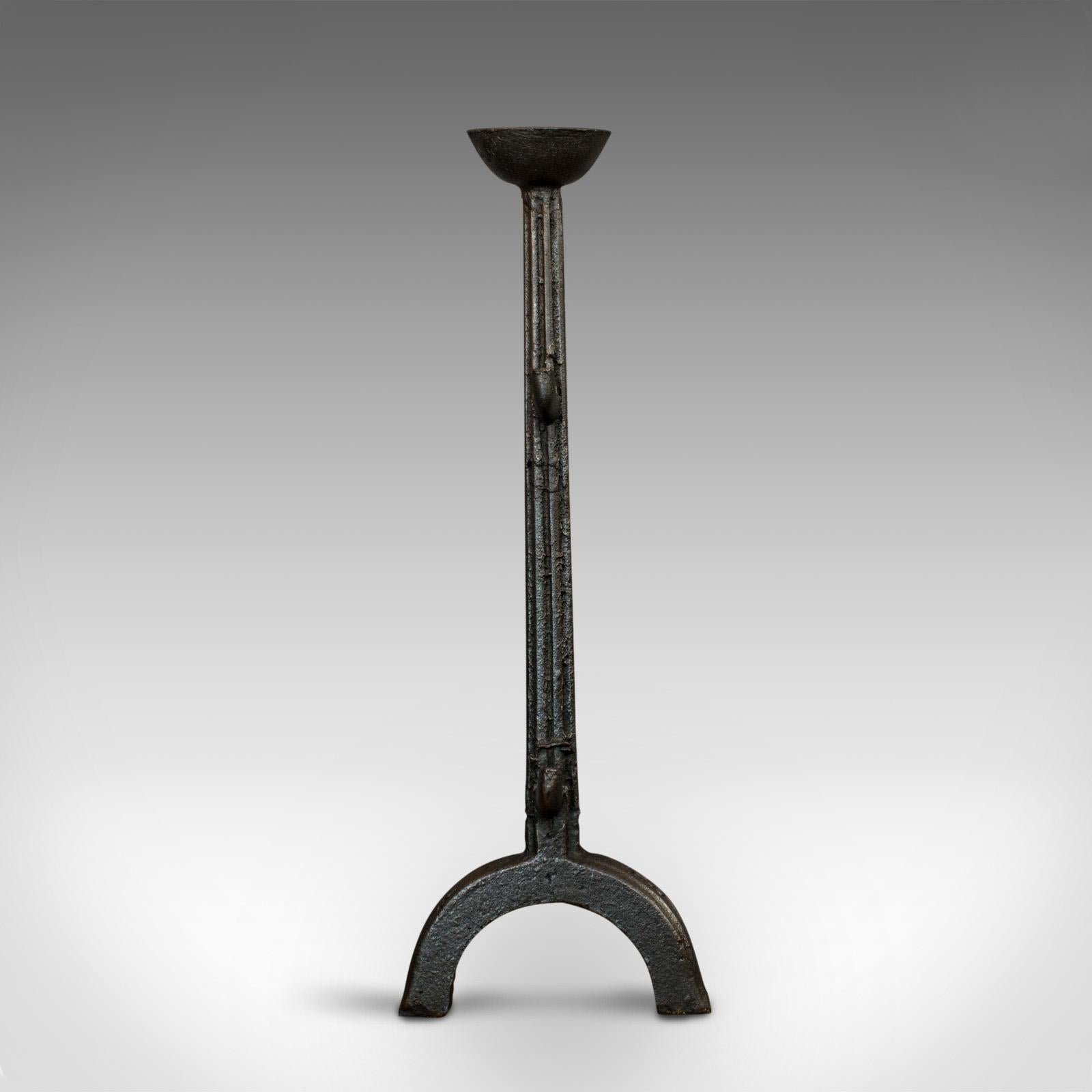 This is a large antique decorative firedog. An English, cast iron fireplace andiron, ideal for large candles, dating to the Georgian period, circa 1800.

Appealing fireside decor
Displays a desirable aged patina
Georgian cast iron in good