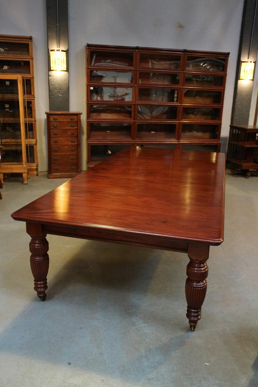 Impressive mahogany English antique mahogany dining room table in very good condition. The table has 3 original extra leaves. Different sizes can be arranged.It is a wind out table using a turning mechanism. The entire system works perfectly. Table