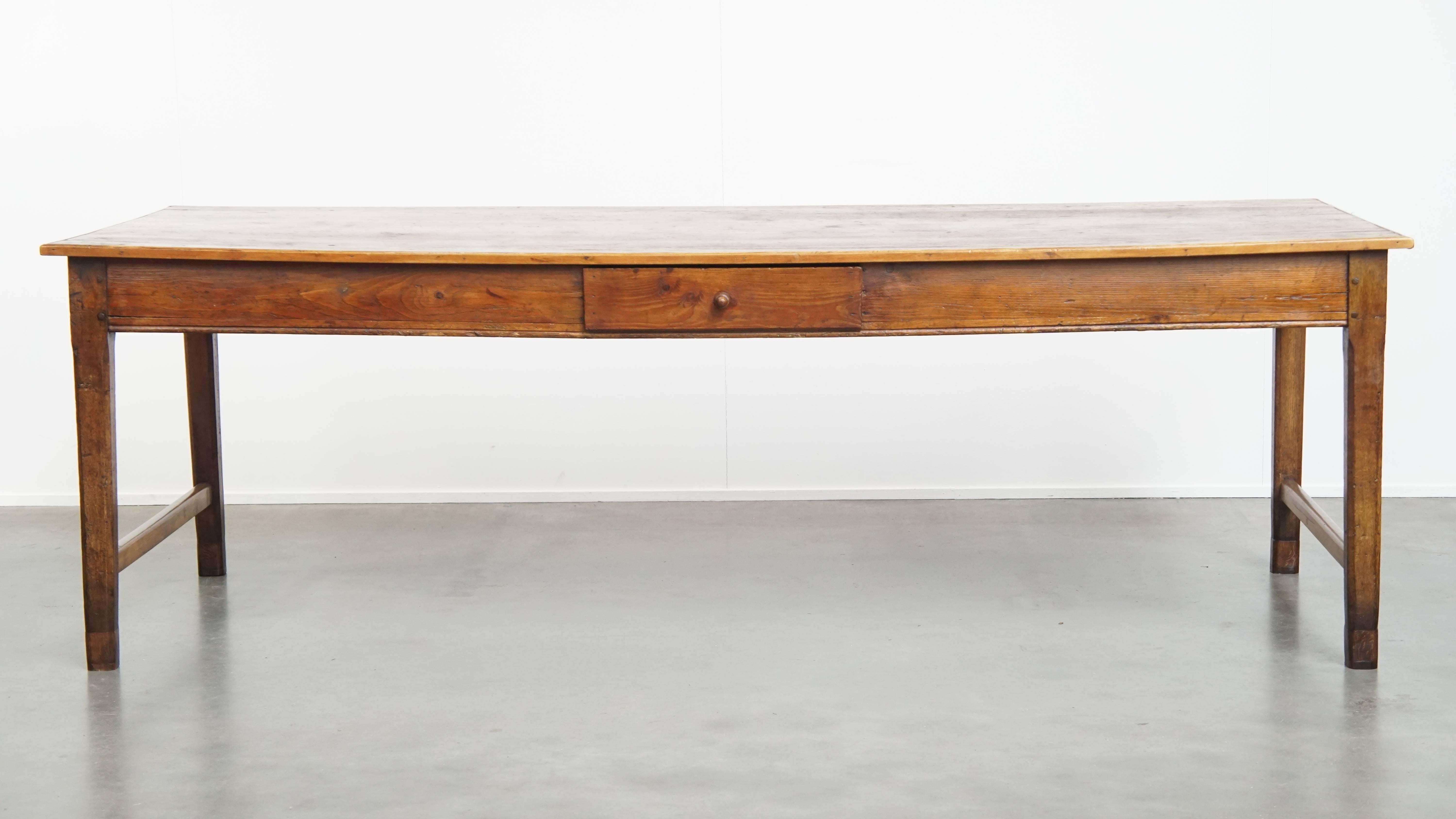 Offered by ByThijs is this charming and large antique dining table featuring a drawer and beautiful original details. 

This stunning and characterful antique table is a unique piece that offers both practicality and atmosphere, making it a perfect