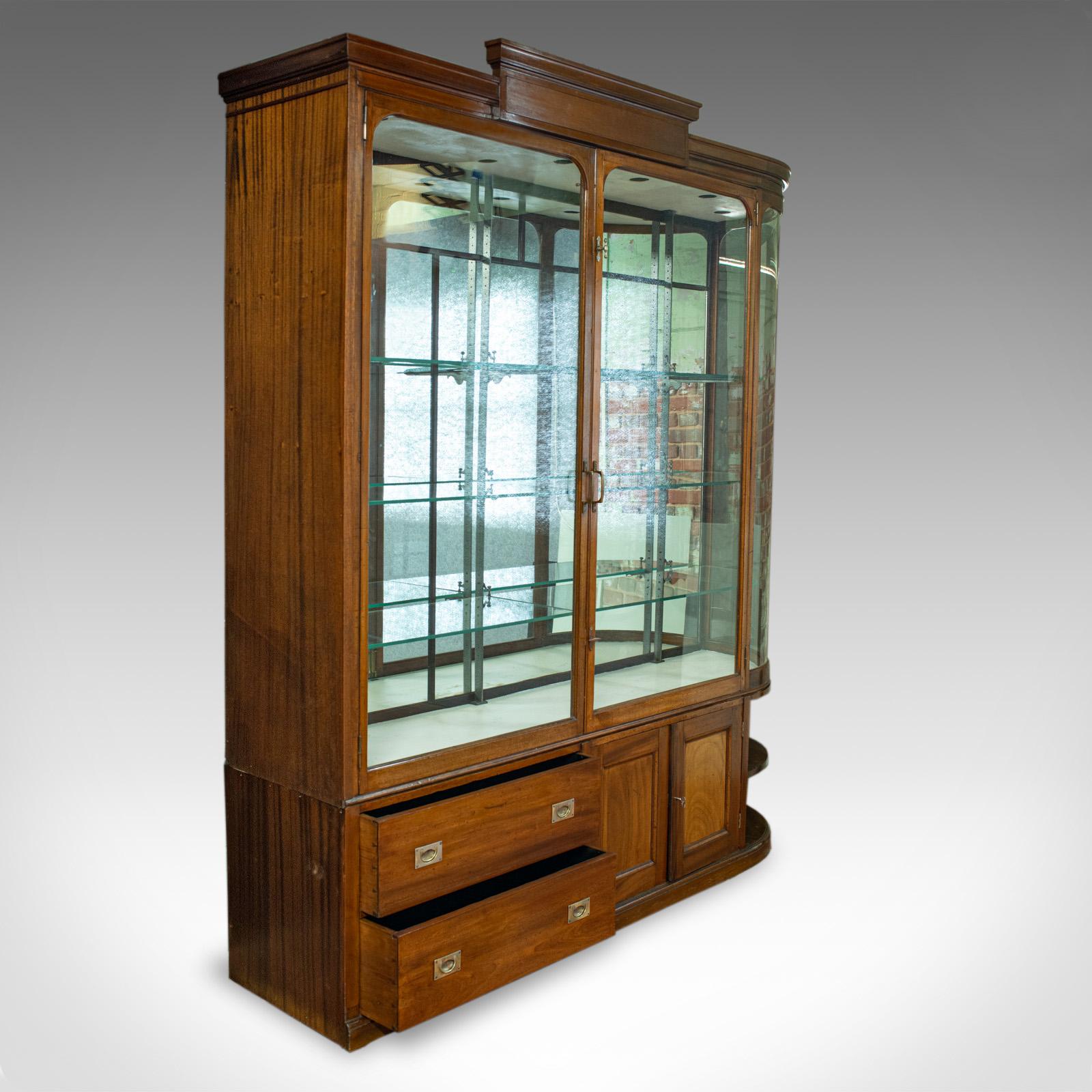 This is a large, antique display cabinet. An English, mahogany and glass retail showcase dating to the Victorian period, circa 1860.

Select mahogany displays rich caramel hues and a fine grain interest
Good color throughout and a desirable aged