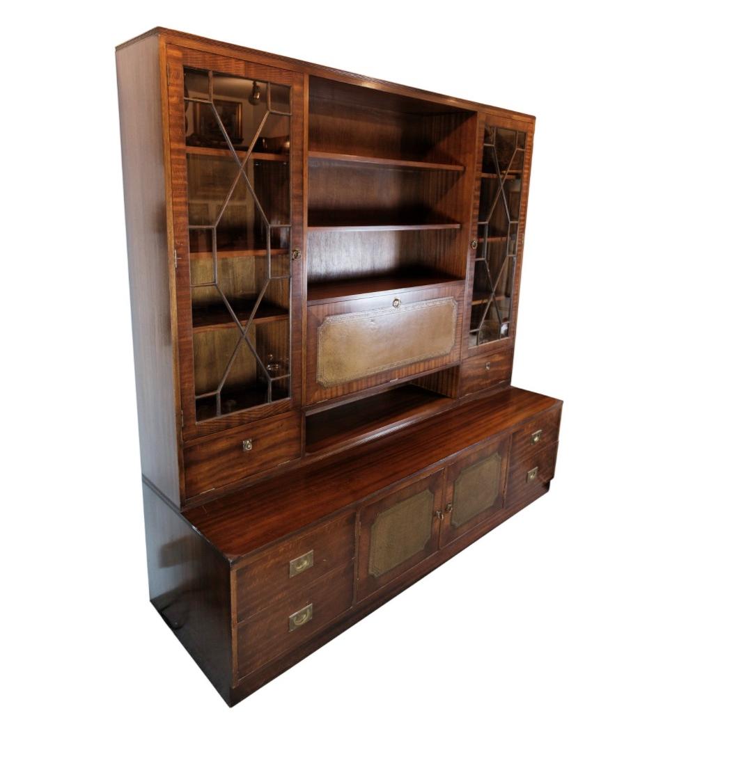 This large antique display cabinet, doubling as a secretary, showcases timeless elegance and functional design. Crafted from rich mahogany, it exudes warmth and sophistication, adding a touch of vintage charm to any space.

Dating back to the 1930s,