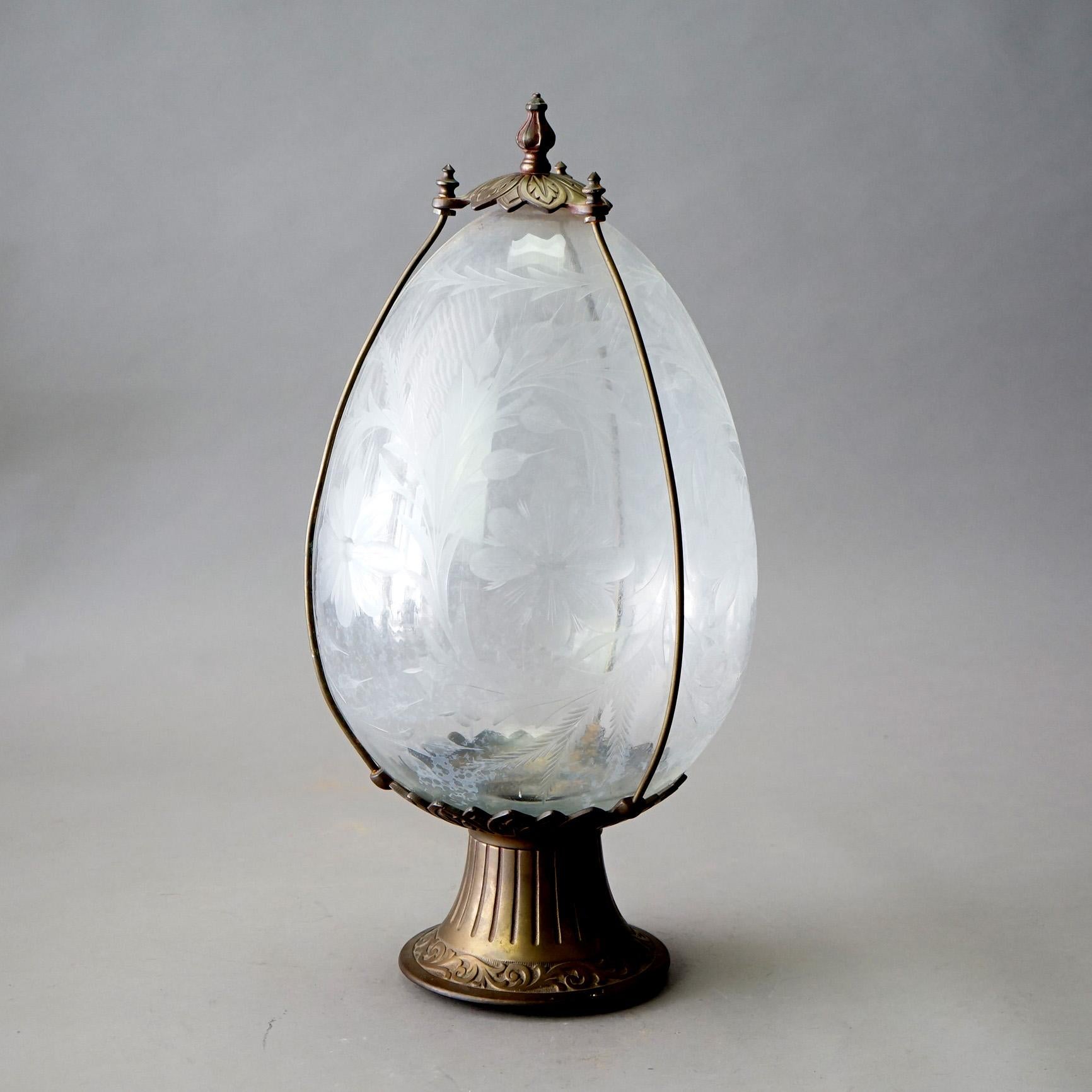 An antique and large drug store apothecary show globe offers tear drop form glass globe having overall floral etched design and housed in a bronzed metal frame with engraved acanthus collar, c1925

Measures- 21.5''H x 10.5''W x 10.5''D

Catalogue