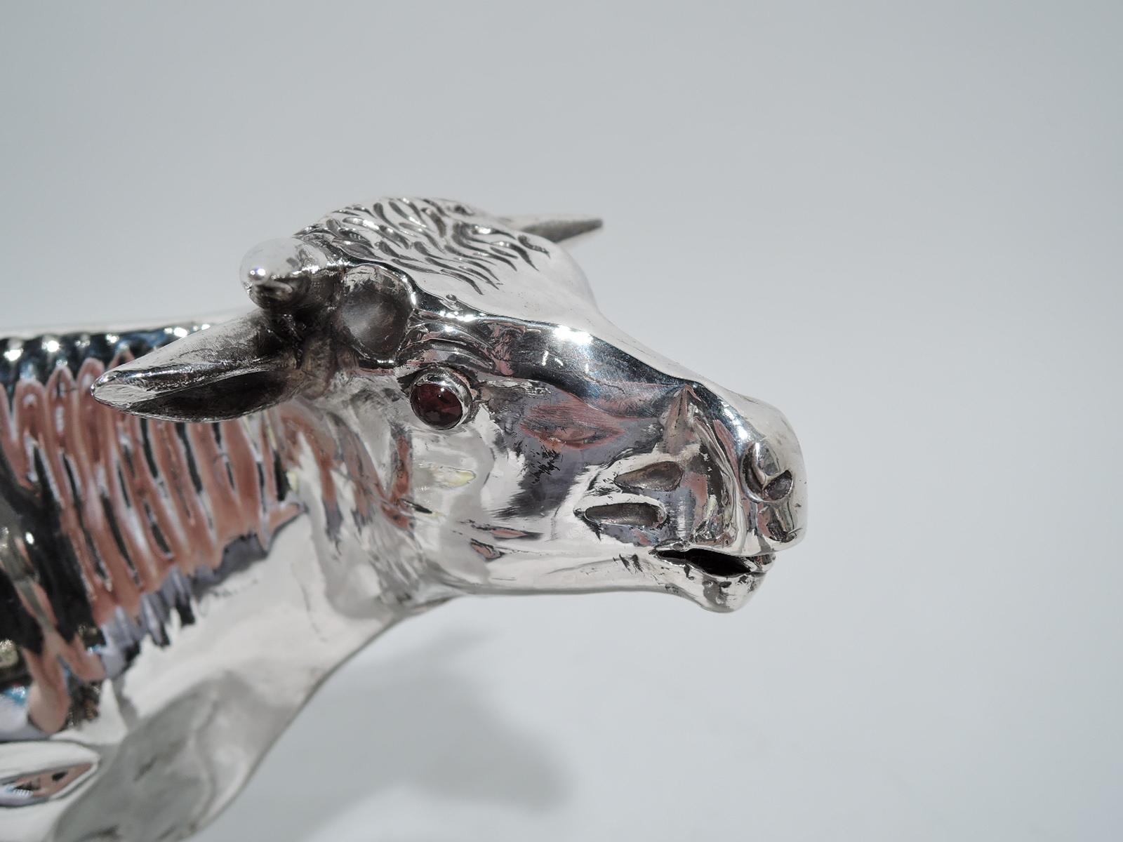 Large Dutch 934 silver cow creamer. Imported to England in 1891 by Edwin Thompson Bryant in London. A stiff-legged quadruped supporting a stocky body with flicked-tail handle. Head turned to side. Eyes red glass beads and mouth gently agape. A major