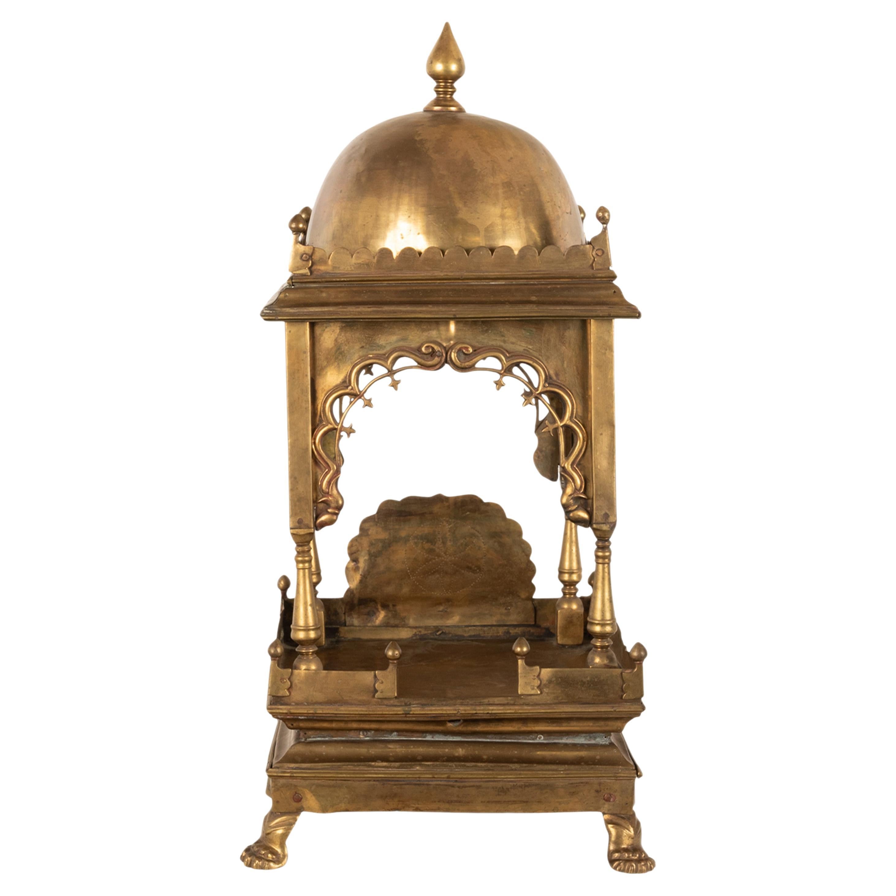 A good & large 19th century antique brass Hindu temple altar shrine, circa 1880.
The shrine in two sections with a domed top and a turned & pointed finial, below is a shaped gallery with smaller corresponding finials at each corner. The base with