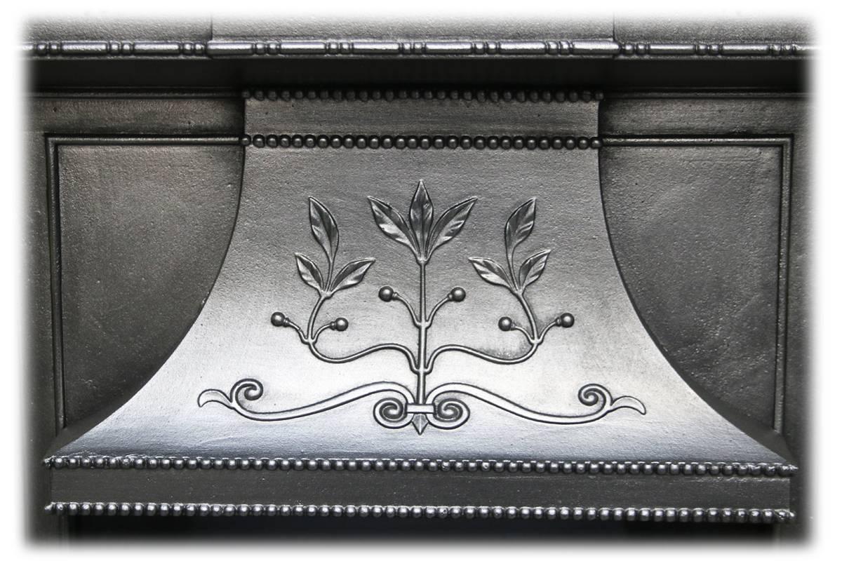 Large antique Edwardian Art Nouveau cast iron combination fireplace. Cast with fine flowing tendrils, stylized flowers and leaves, typical of the Art Nouveau style, circa 1905. 
Complete with a set of original Art Nouveau fireplace tiles.
This