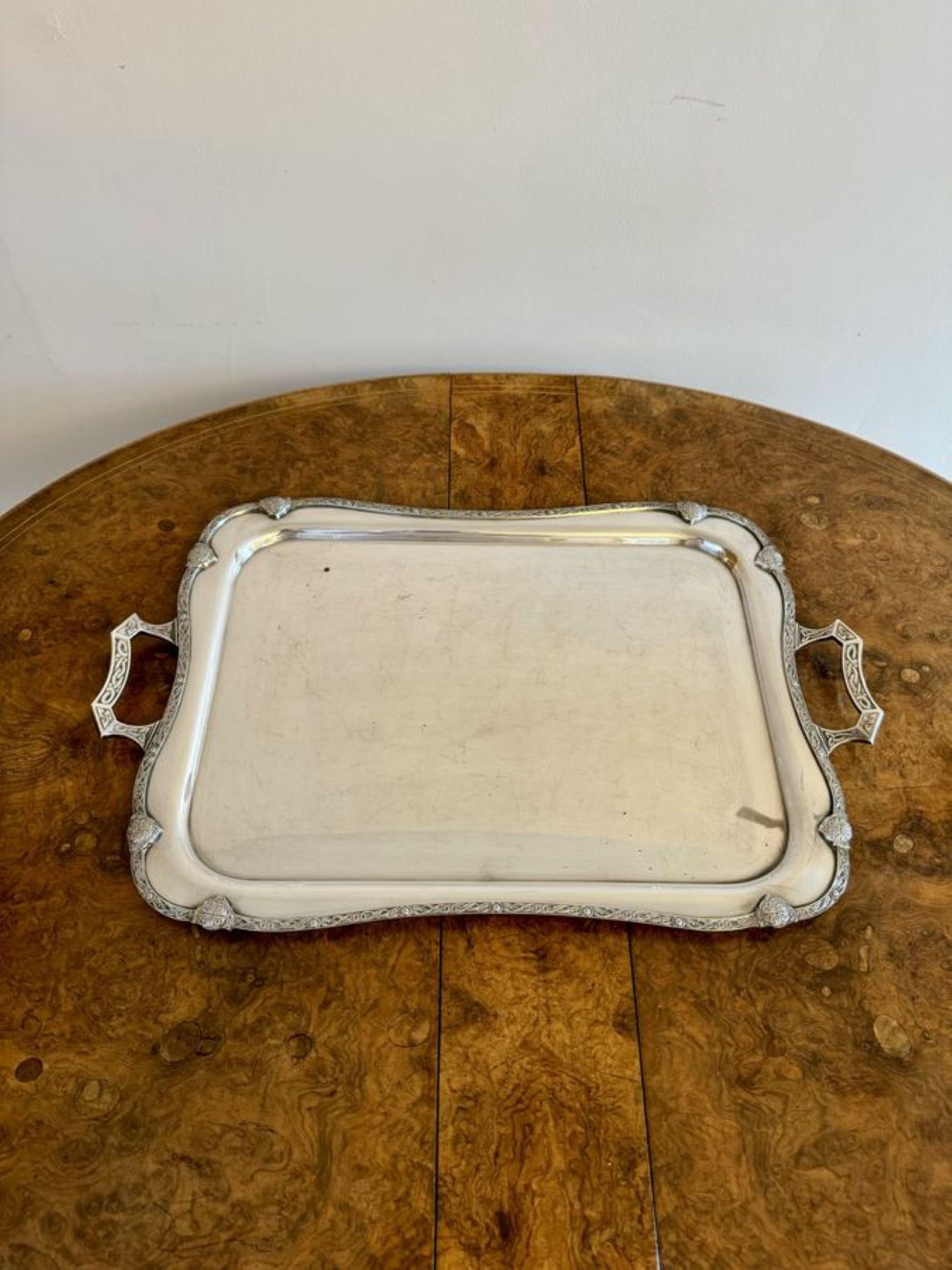 Large antique Edwardian silver plated tea tray, having a quality silver plated antique Edwardian tea tray, with two shaped ornate handles to the sides and an ornate border. 

D. 1900