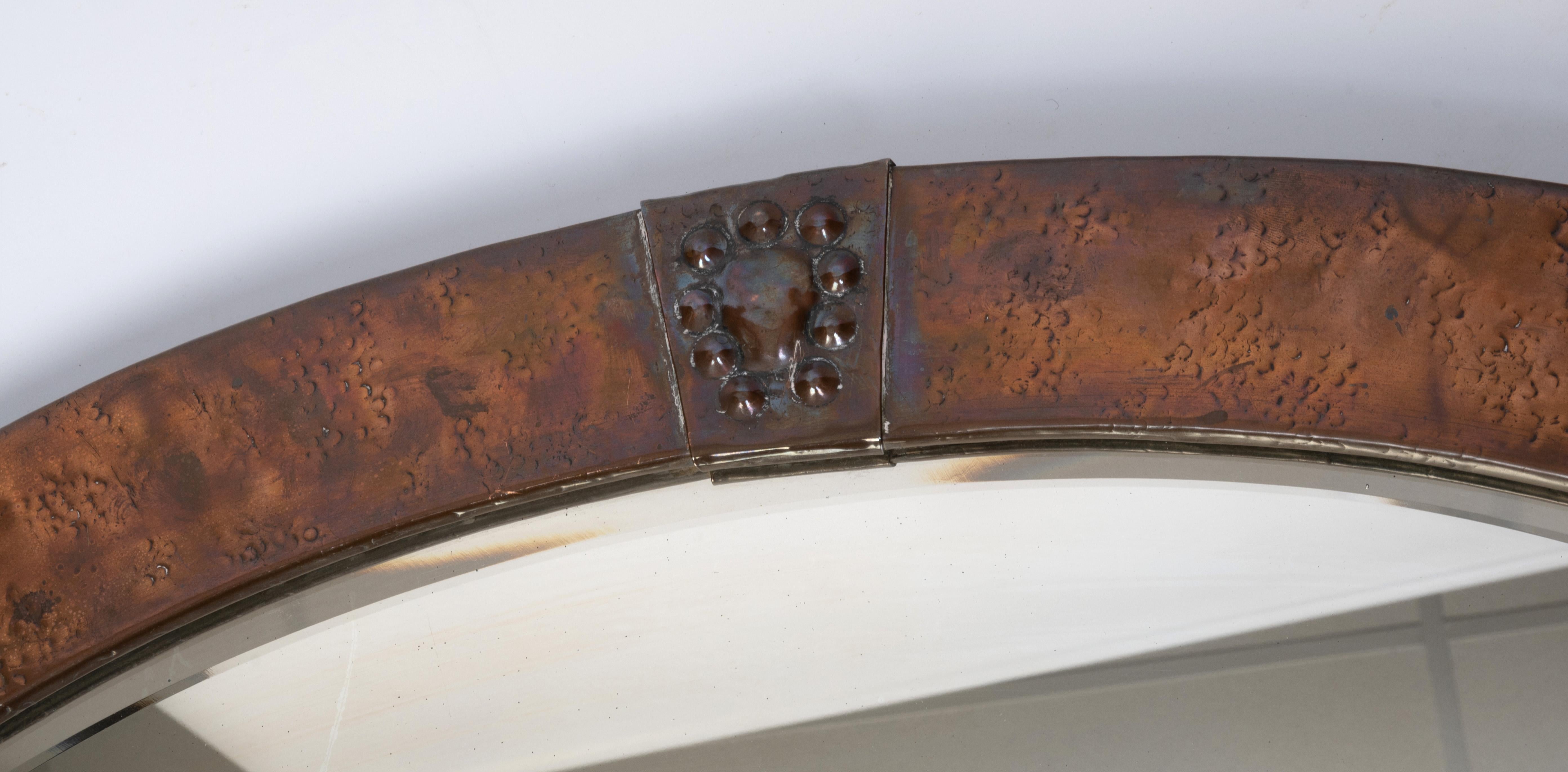 Large Antique English Arts & Crafts Copper Oval Mirror Liberty & Co.
C.1900
Hammered copper with roundel detailing.
In very good condition, original patinated copper and bevelled mirror.
