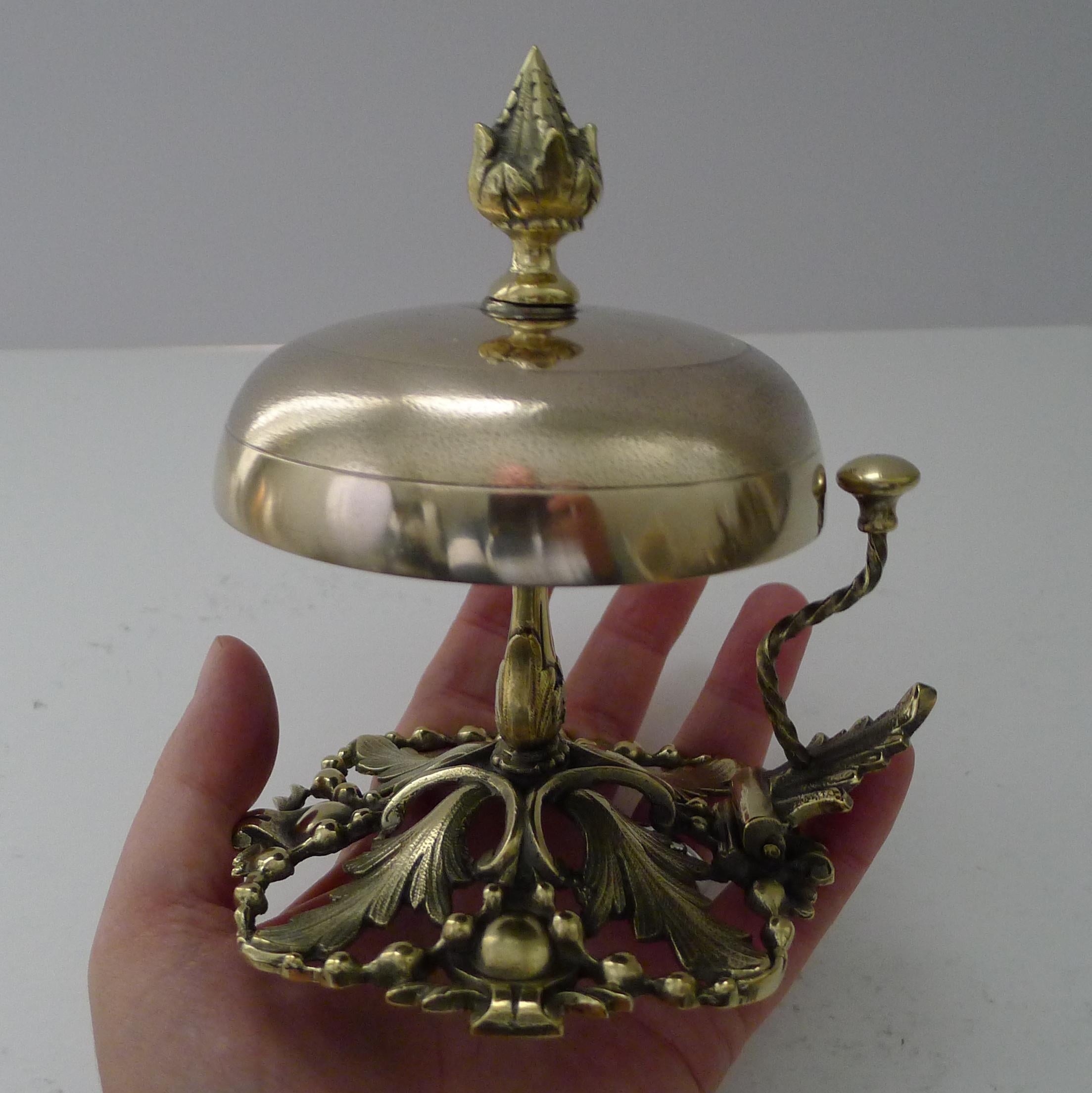 A wonderful and highly decorative desk or counter bell, my favourite kind with the more unusual clapper to the side rather than the ones you ring from the top. The hinged clapper is released and gives a clear and authoritative ring.

The reticulated