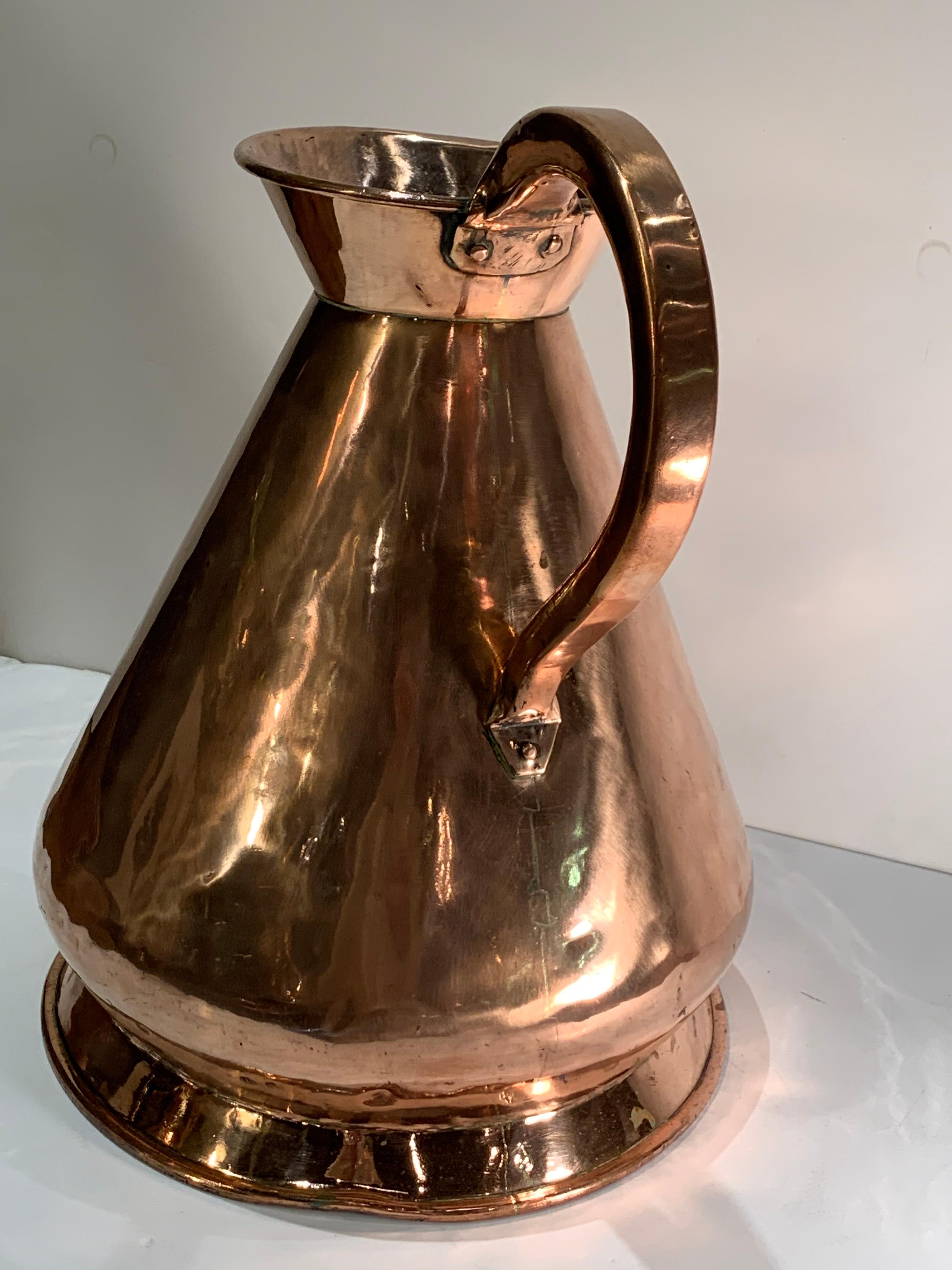 A large antique English copper pitcher. The form refereed to a 