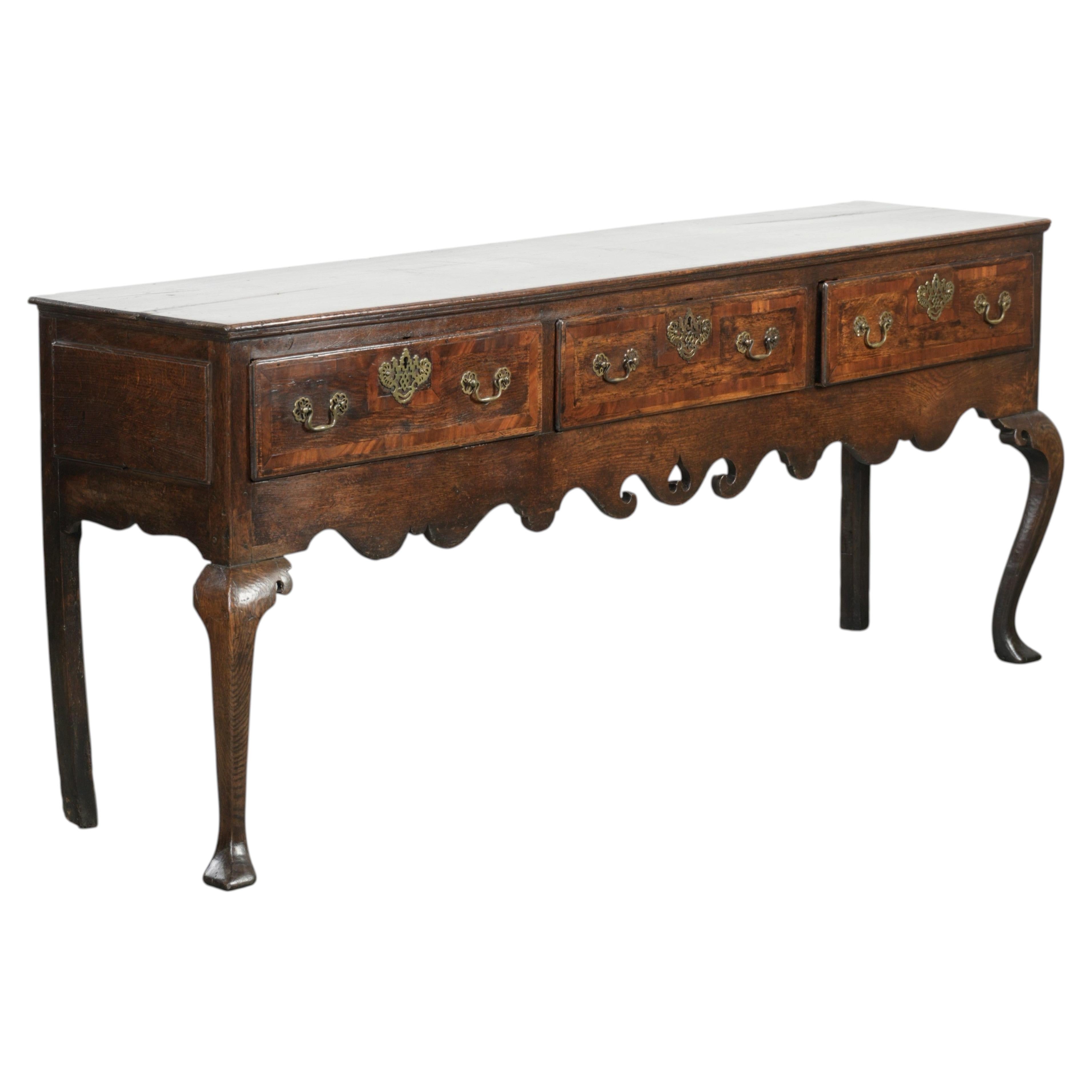 Large antique English oak sideboard from the 18th century with elegant legs