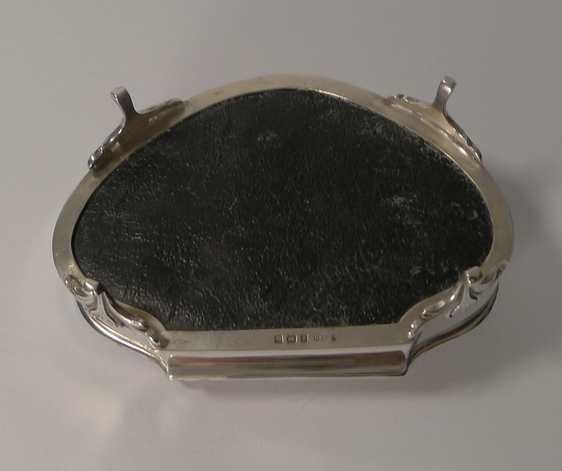 A beautiful heavy jewelry box made from English sterling silver standing on four stunning legs.

A superb shape is highlighted by a raised border surrounding a guilloche / engine turned decoration splaying out from the central circular cartouche