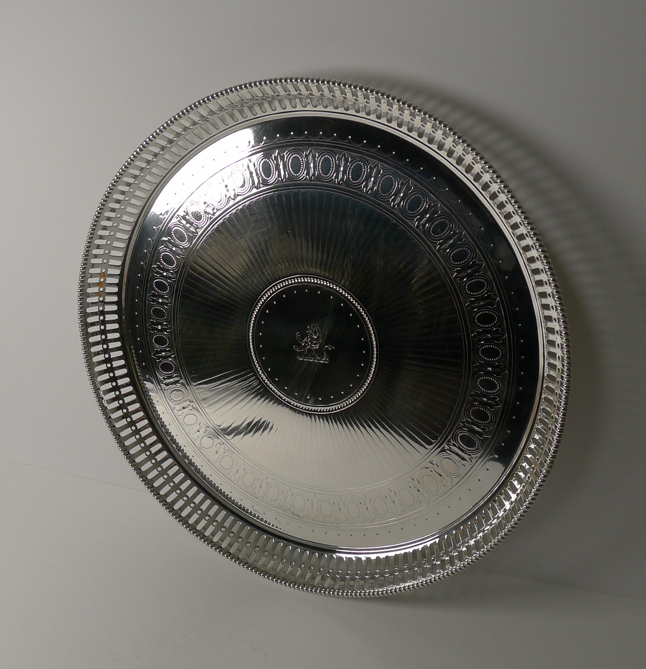 A stunning large antique English circular drinks tray made in silver plate by the top notch silversmith, Elkington and Co.; fully marked on the underside. Being Elkington, we are able to date the piece accurately (letter O) to the year 1875, a true
