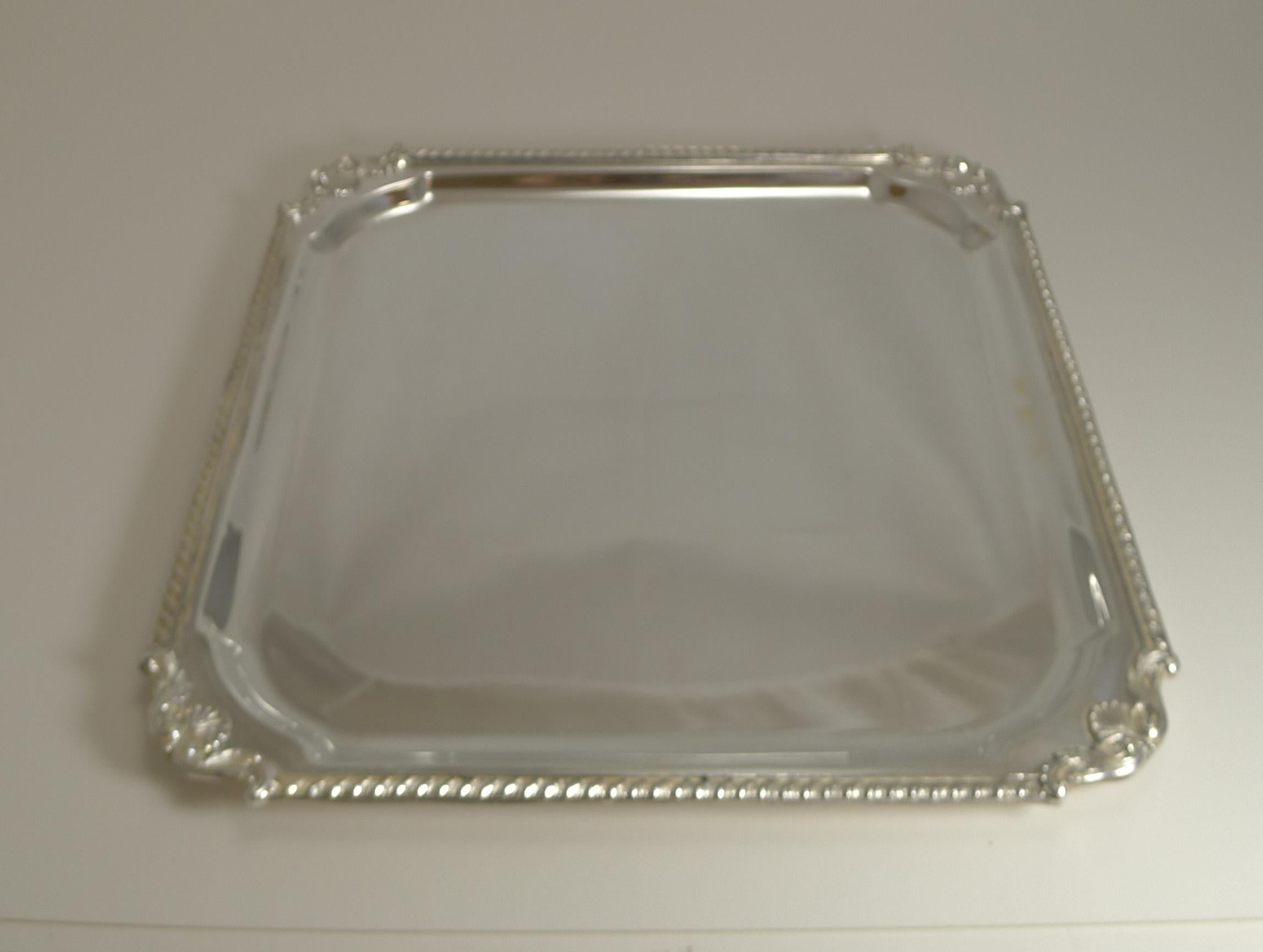 A very smart antique English square drinks tray or salver with a decorative raised border.

The underside is fully marked for the top-notch silversmith, Mappin & Webb. Dating to circa 1900, it remains in excellent condition.

A good large size