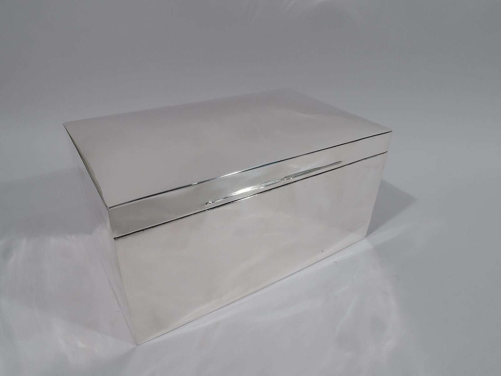 Large Victorian sterling silver box. Made by Mappin & Webb in London in 1899. Rectangular with straight sides, Cover hinged and gently curved with double tapering tabs. Box and cover interior cedar lined with detachable partitions. Box underside