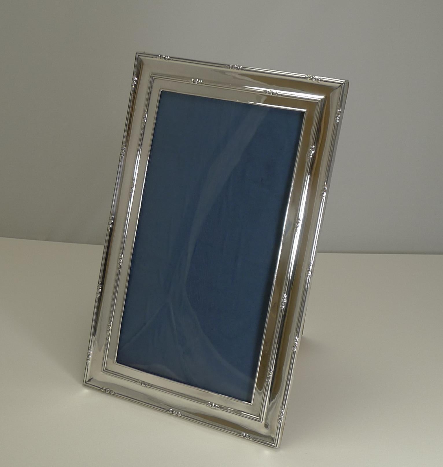 A very smart large picture frame made from English sterling silver with a solid oak backing.

What makes this a highly desirable example is the opportunity to use as both a portrait and landscape frame, versatile and very usable.

The silver is