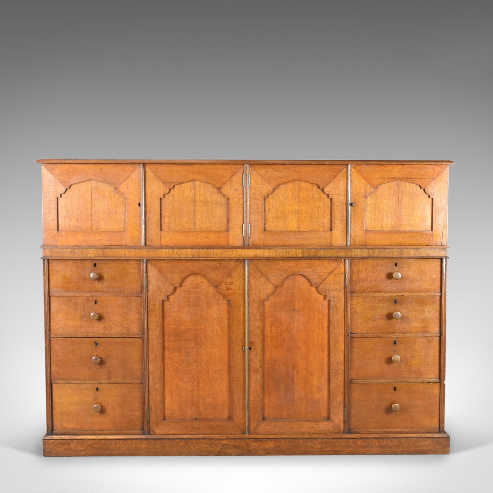 This is a large antique estate manager's cupboard in oak. An English, Victorian cabinet of country house proportions dating to the late 19th century, circa 1880.

A super piece of English estate furniture
The quarter sawn oak displaying wisps of