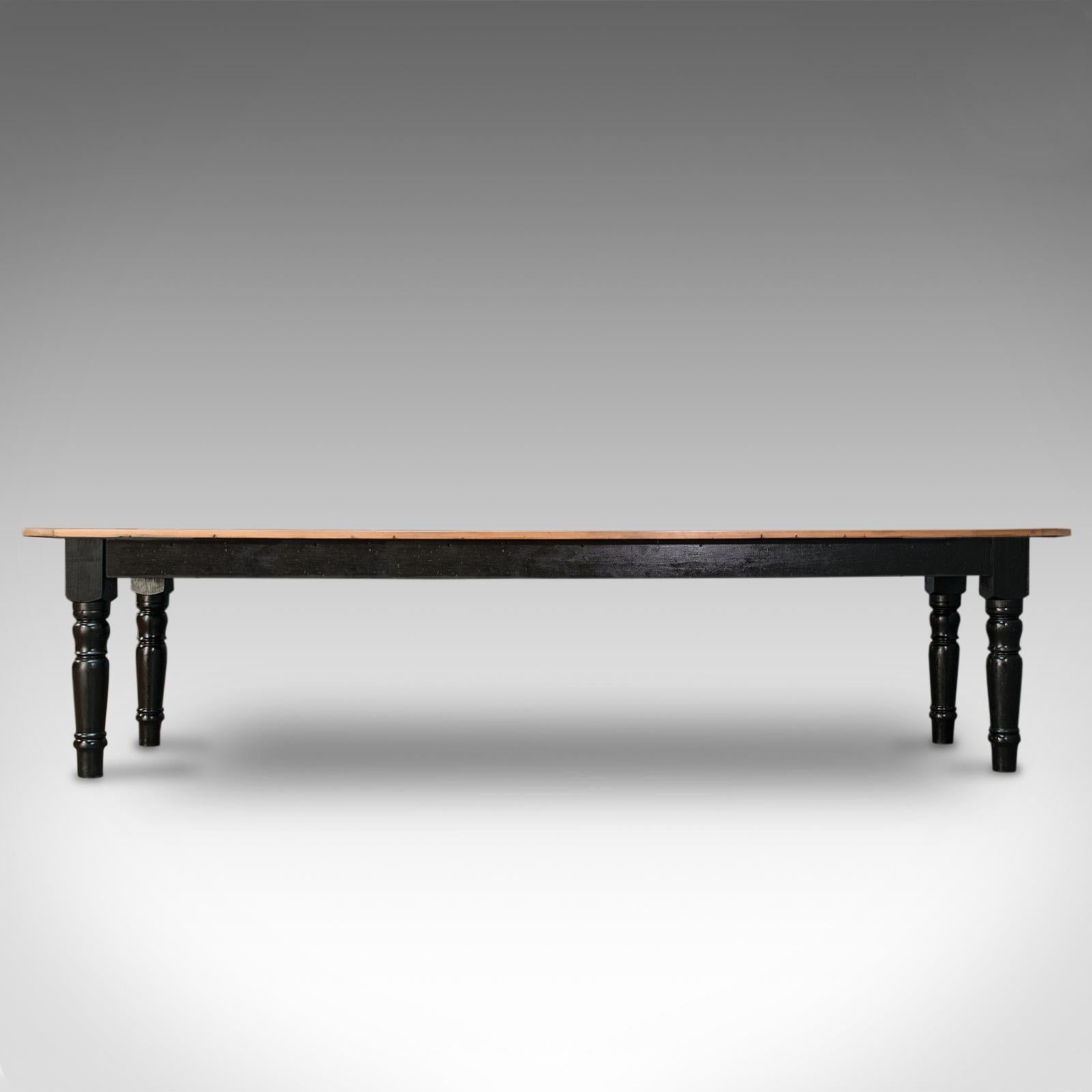 This is a large antique farmhouse dining table. An English, pine and traditionally ebonised pine kitchen or country house table for 10-12 people, dating to the Victorian period and later, circa 1900.

Wonderfully proportioned for the large family