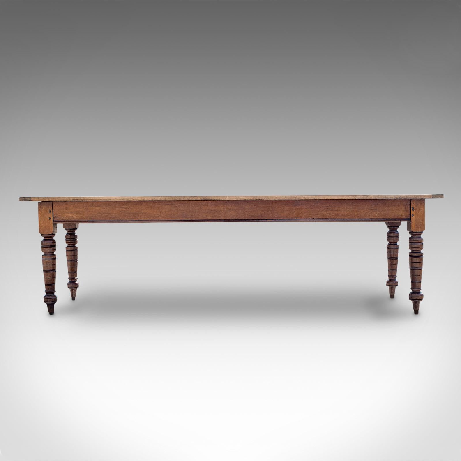 This is a large antique farmhouse table. An English, mahogany and pine dining or kitchen table for 8-10 people, dating to the Victorian period and later, circa 1900.

Generous proportions of 8' 6