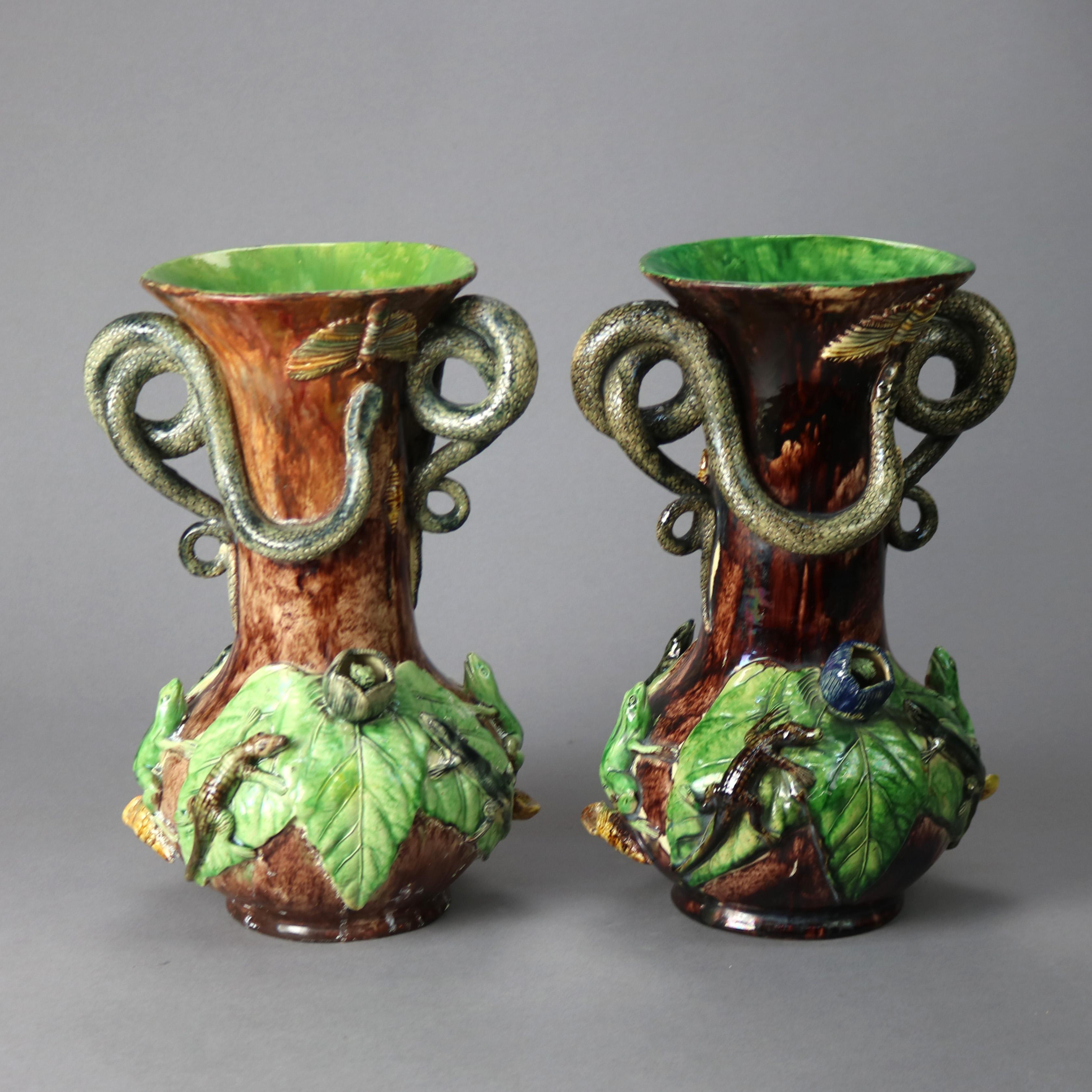 An antique pair of figural Palissy Ware Majolica pottery vases of Mafra Portugal, offer bulbous form with leaf and reptile design including snakes, frogs, and lizards; maker marks on bases as photographed; 19th century.

Measure - 13.25