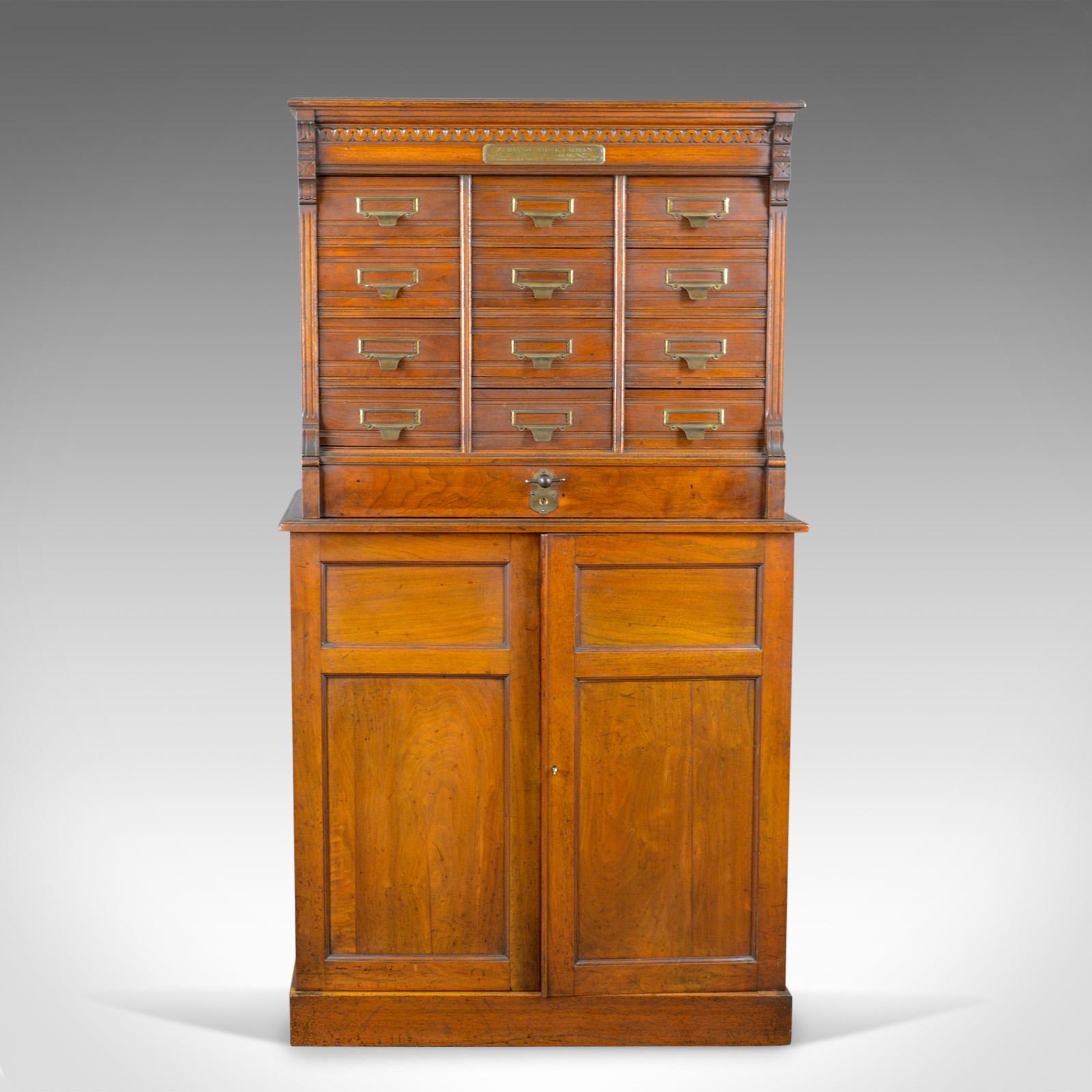 This is a large antique filing cabinet, an English, Edwardian walnut cupboard by renowned cabinet makers Shannon File Co., London and dating to the early 19th century, circa 1910.

Magnificent antique filing cabinet
English walnut displaying good