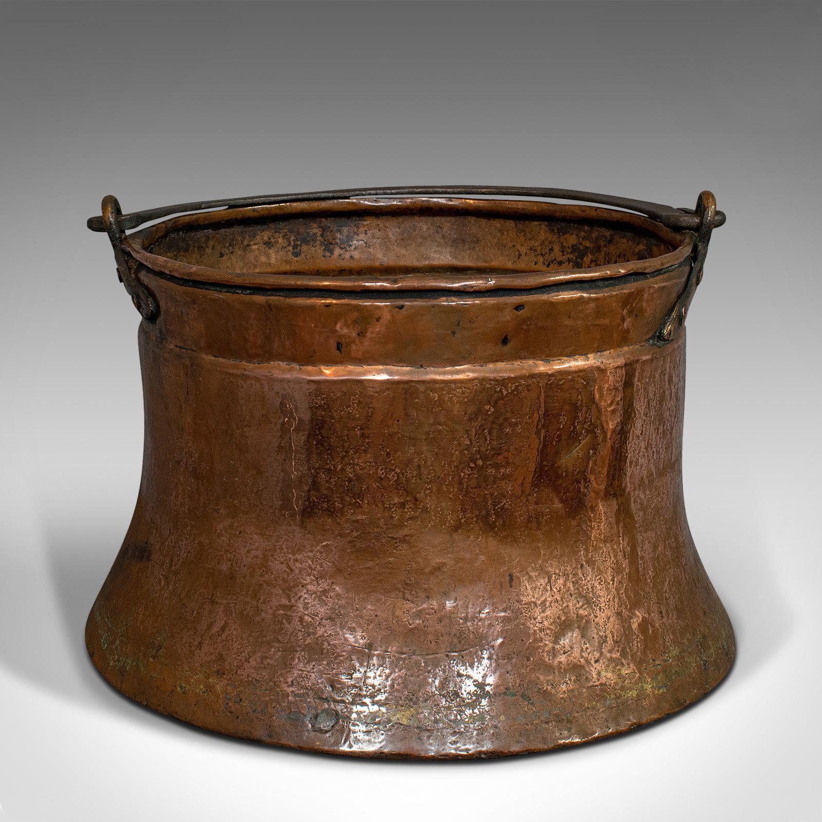 This is a large antique fire bucket. An English, copper elephant's foot fireside log or coal cauldron, dating to the Georgian period, circa 1800.

Delightful form and function
Displays a desirable aged patina
Copper resplendent with rich