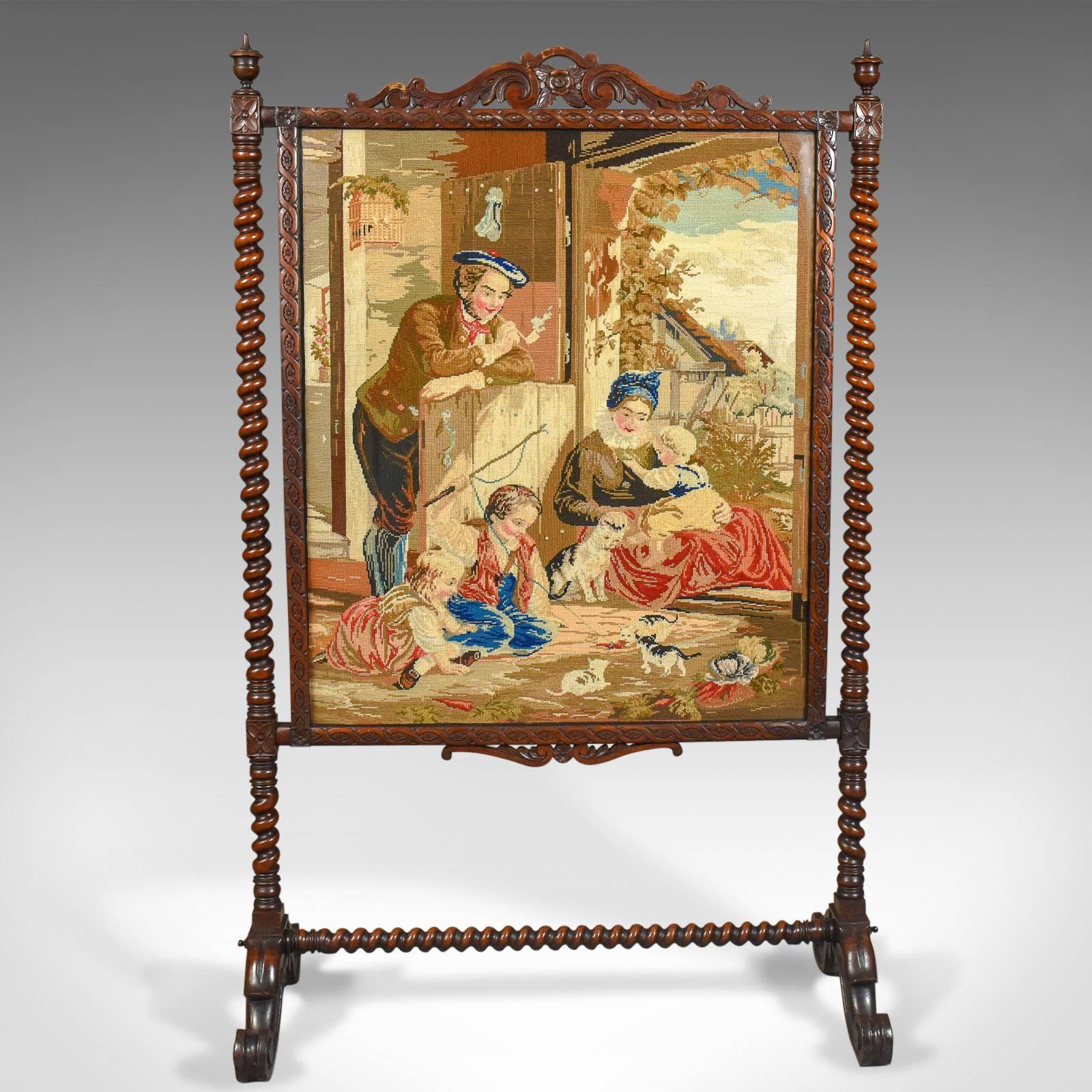 This is a large antique fire screen with needlepoint tapestry panel in a walnut frame, dating to circa 1850.

Superb needlepoint tapestry panel
Retaining good color and detail, noticeably in the clouds
A farmhouse scene of a family watching