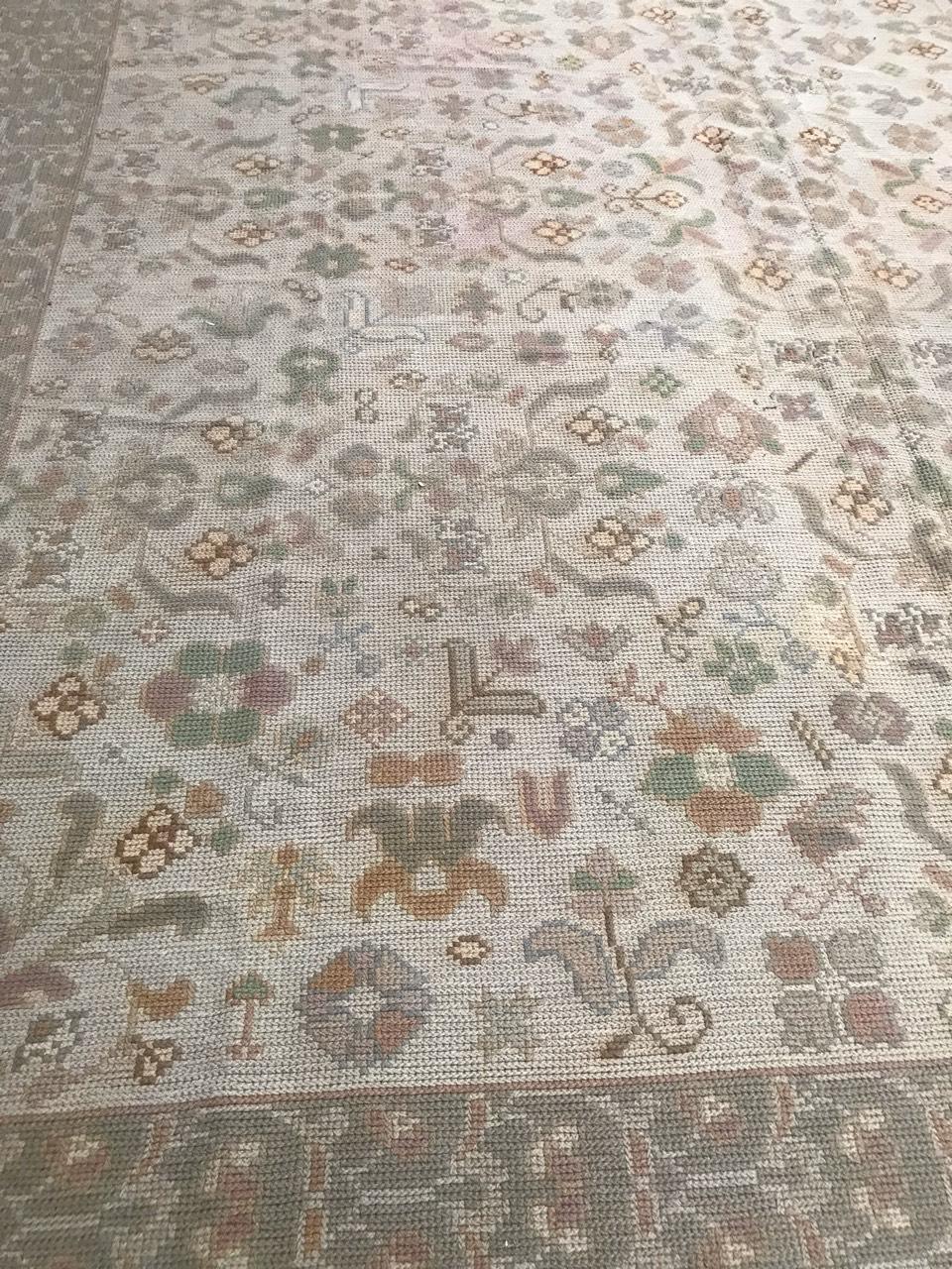 Beautiful antique Portuguese rug from Arraiolos, with a decorative design and light colors with beige and green, entirely hand embroidered with Portuguese needlepoint method, with wool on jute foundation.