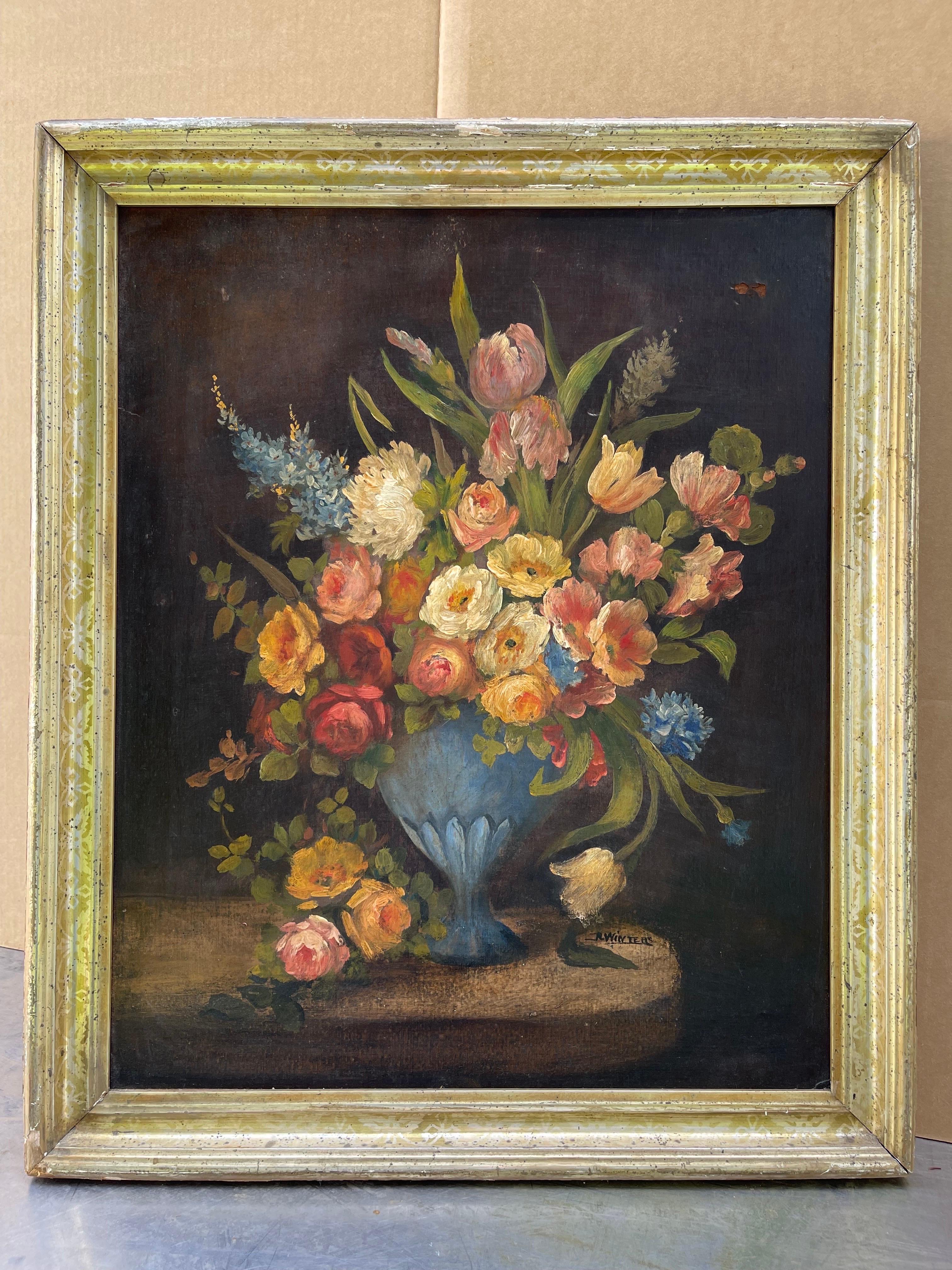 Large Antique Floral Still Life on Board. Dramatic dark background with blue urn full of flowers. Housed in a worn gold gilt frame. Please confirm dimensions prior to purchase.