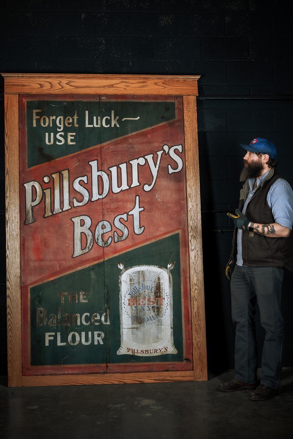 This large sign advertises for Pillsbury's Best Flour. The sign has brilliant red and green color with white lettering. This sign is divided into two sections down the middle and is then framed. Please take a close look at each of the photos