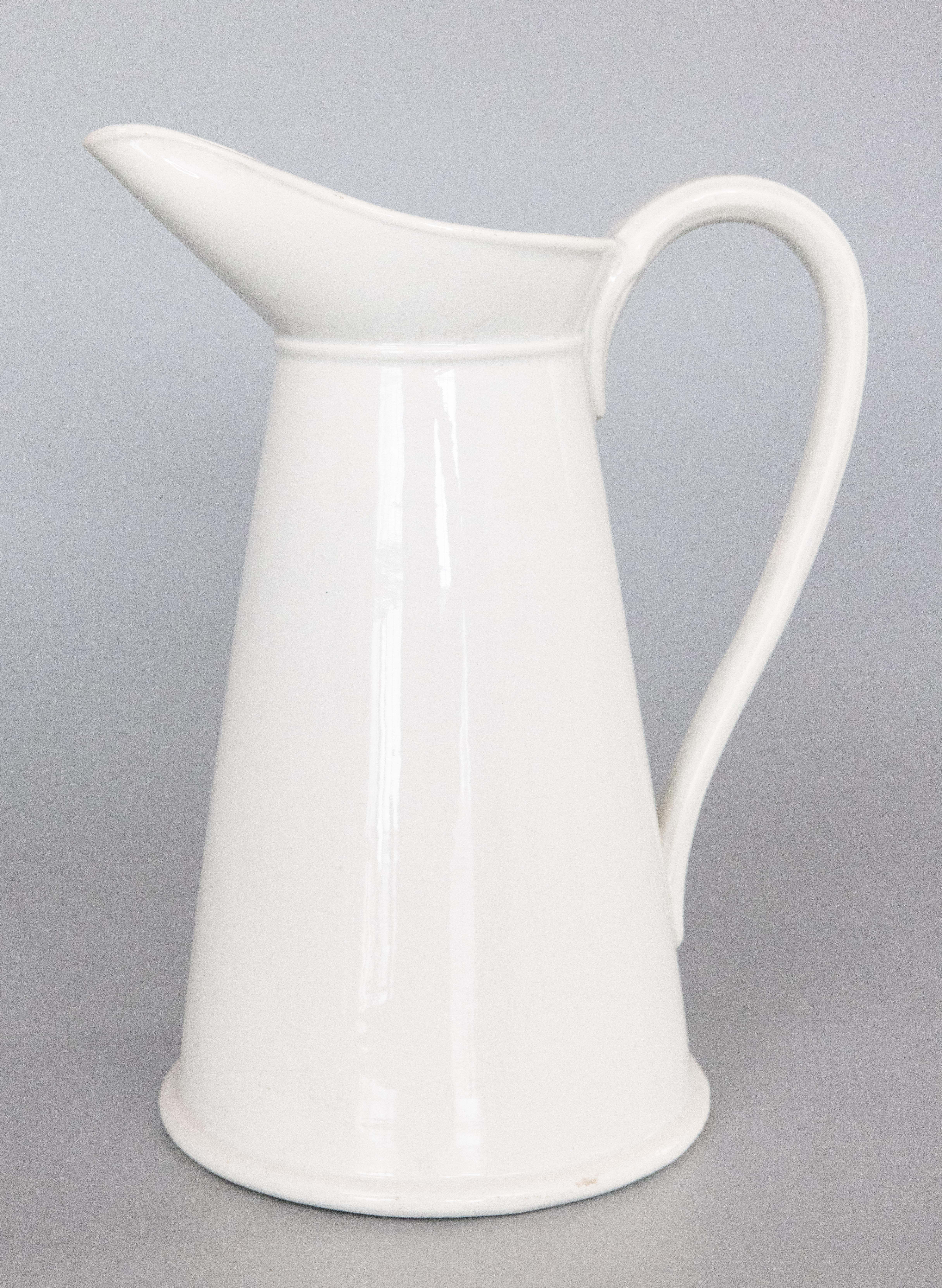 A lovely large antique French white ironstone pitcher, circa 1880. Made in France by the famous Hautin Boulenger & Cie earthenware factory located in Choisy le Roi, France. Signed on reverse. This fine quality pitcher is a nice large size measuring