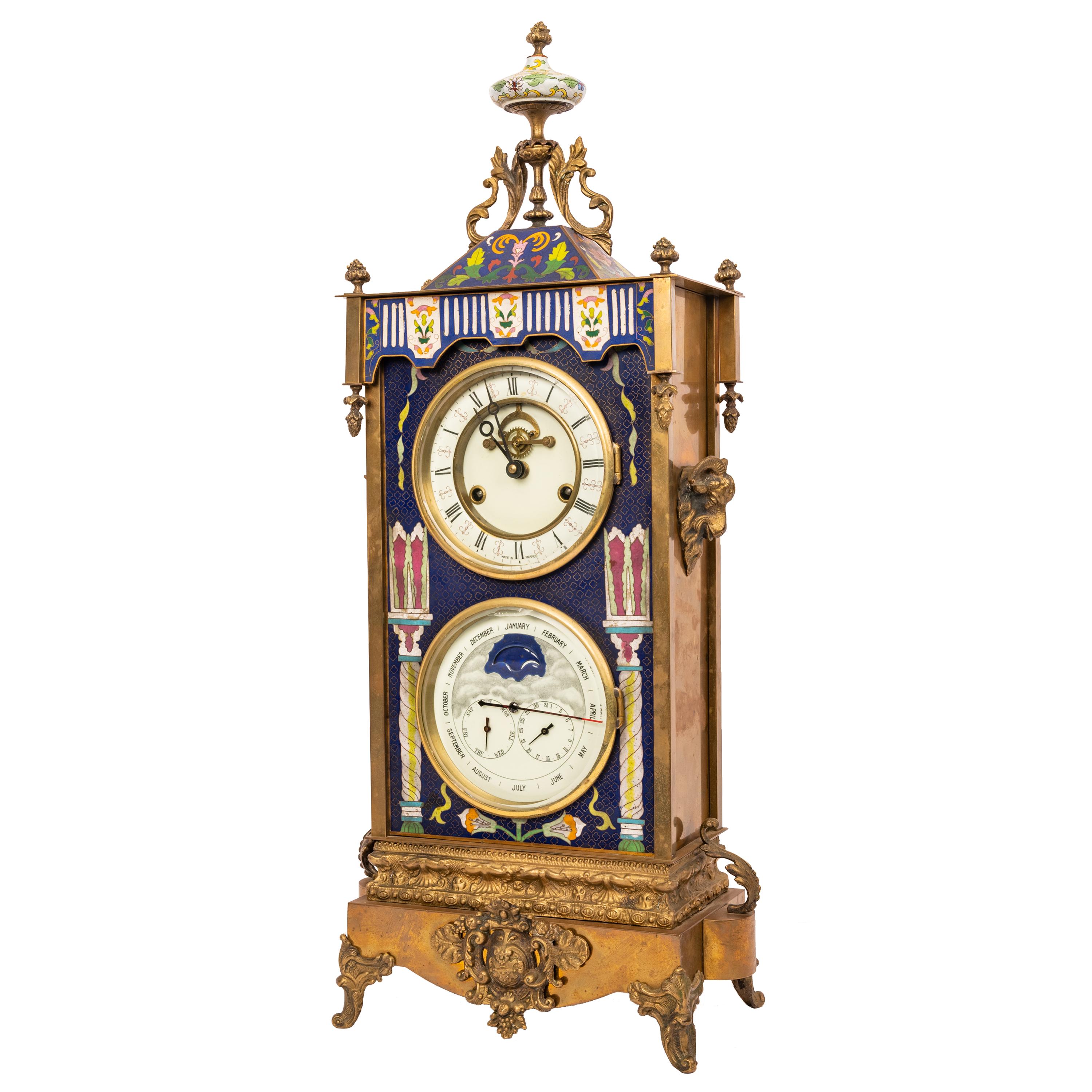 A good and large antique French brass Cloisonné eight day time and strike astronomical calendar clock, circa 1890.
The clock having a porcelain finial to the top decorated with a landscape scene. Below is a cloisonné trapezoid shaped top surrounded