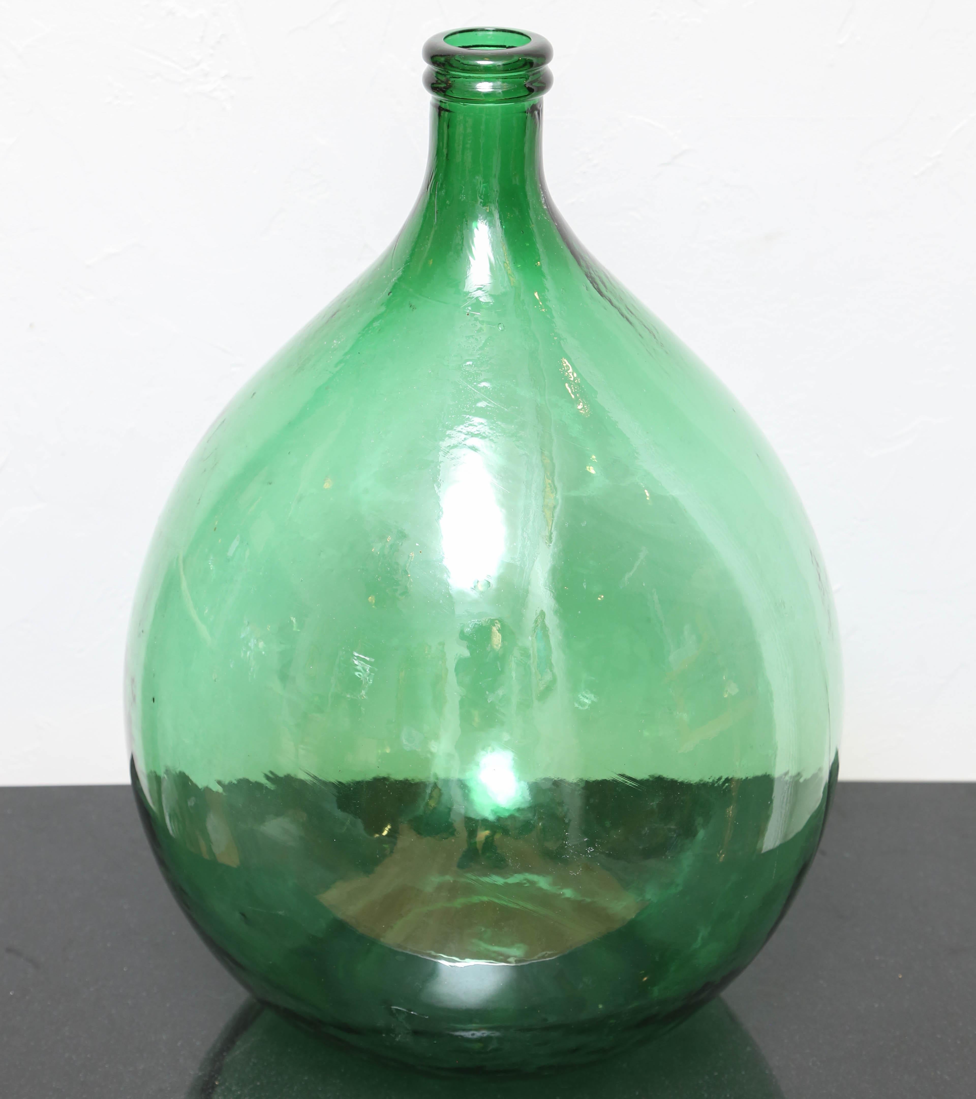 Large translucent green glass wine vessel.