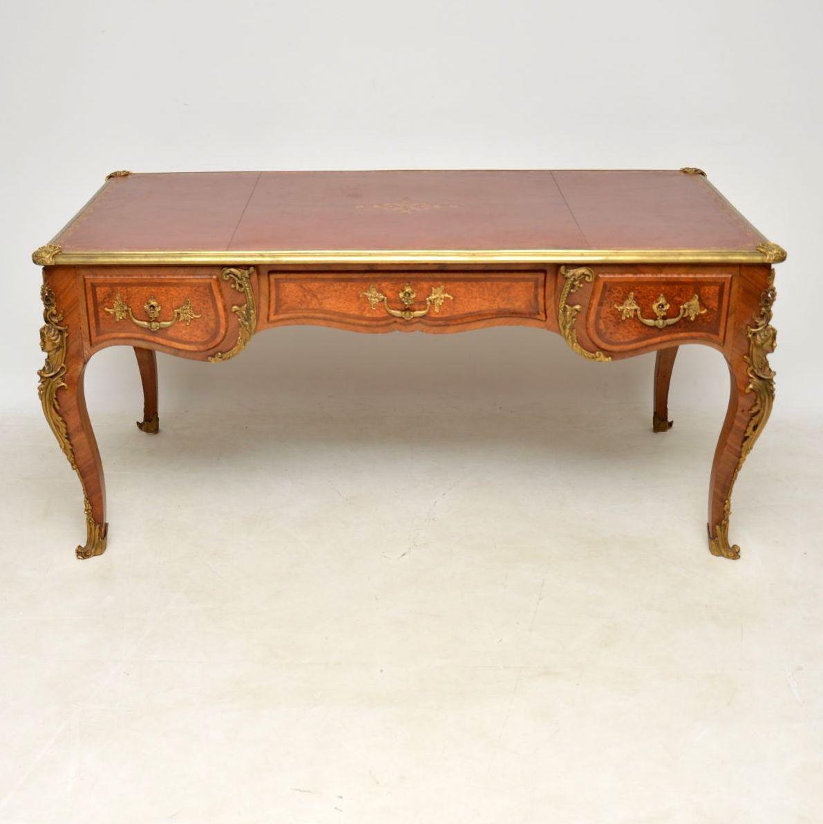 Large antique French desk with an original tooled leather writing surface and fabulous gilt bronze mounts. I would date it to circa 1890-1910 period and it’s in good original condition. It’s excellent quality with oak lined drawers and Fine