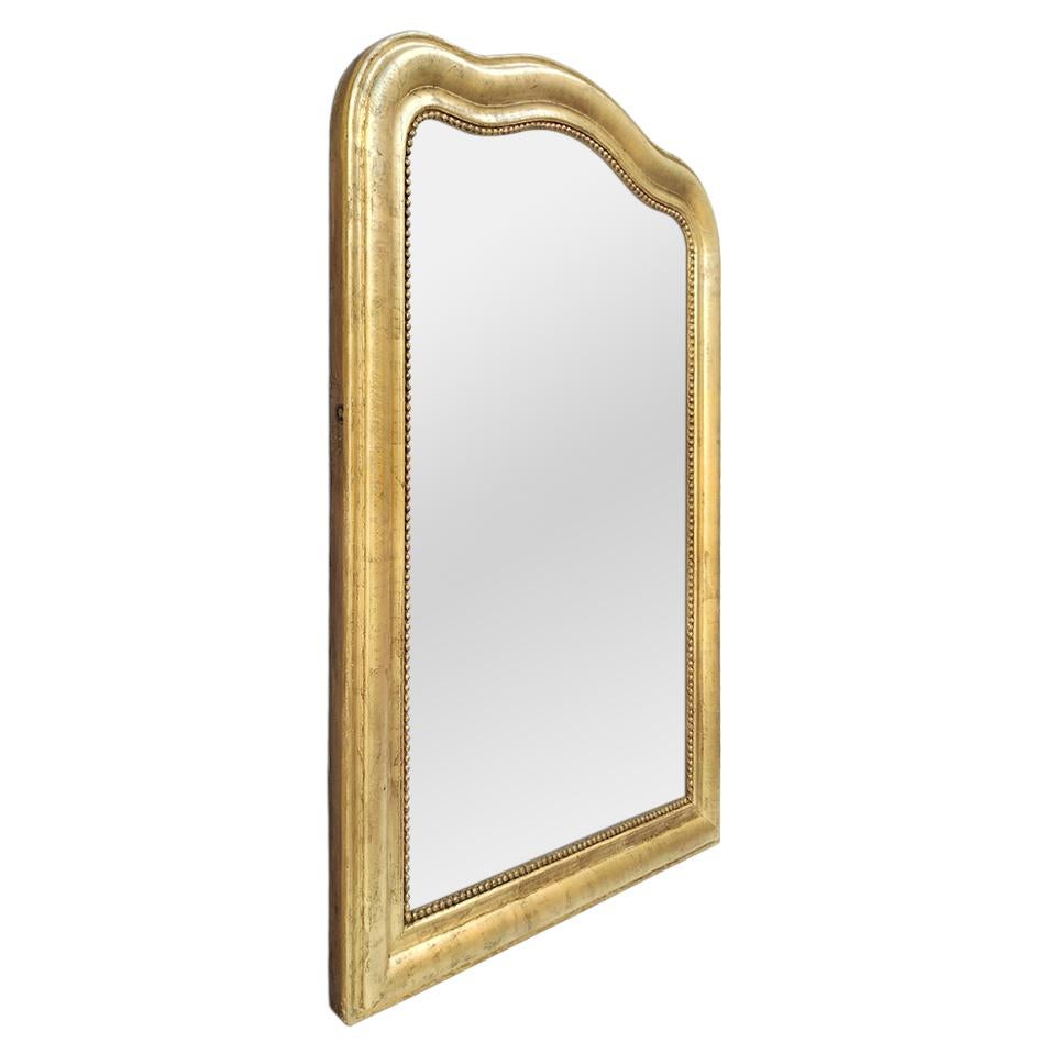 Large antique Louis-Philippe style giltwood mirror. Upper part in the shape of 