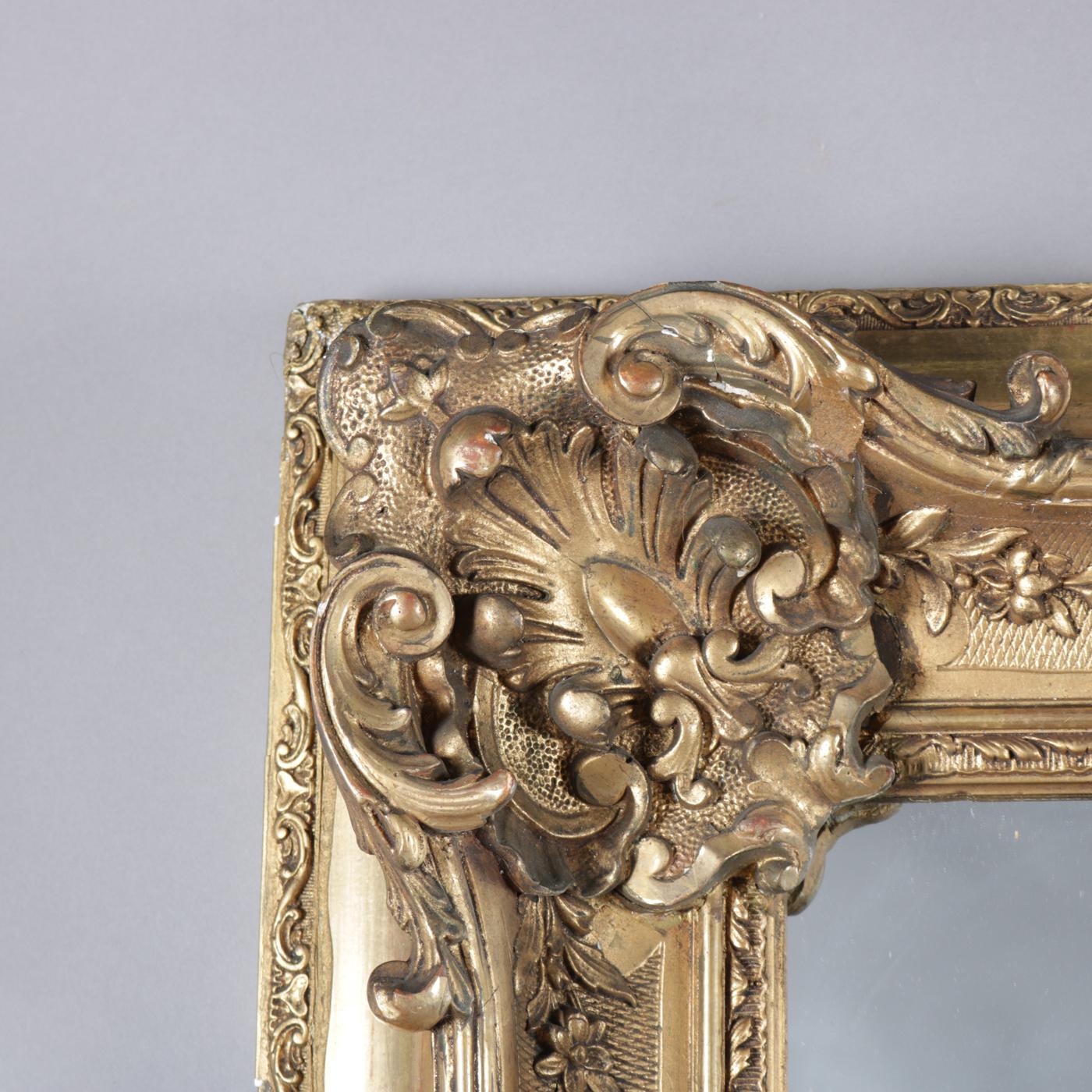 An antique and large French Louis XIV style wall mirror features giltwood frame with foliate, scroll and palmette decoration, 19th century

Measures: overall 43