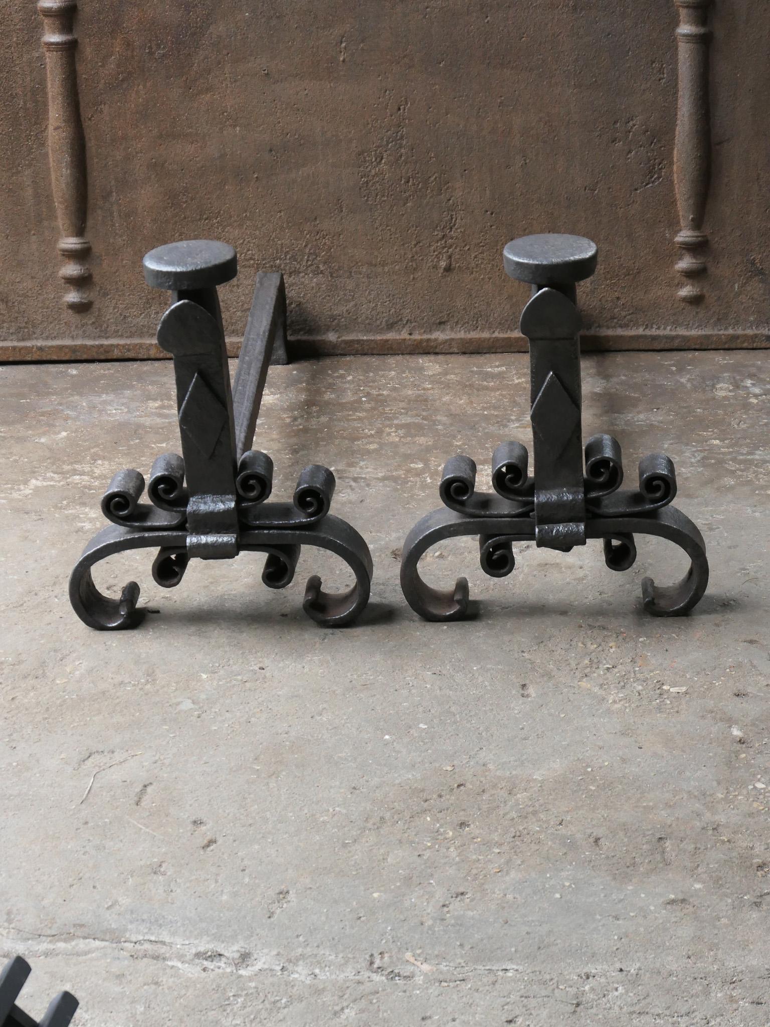 Large 18th Century French Louis XV period andirons. Hand forged of wrought iron. The andirons have spit hooks and are called landiers in France. 

The andirons are in a good condition and are fully functional. 
