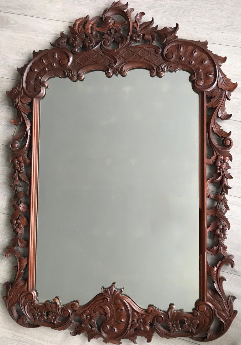 Antique, one of a kind and highly decorative mirror. 

This beautifully hand carved antique mirror frame is in great condition. It is perfectly carved with a decor of scrolling branches and leafs and flowers all around. The top is beautifully