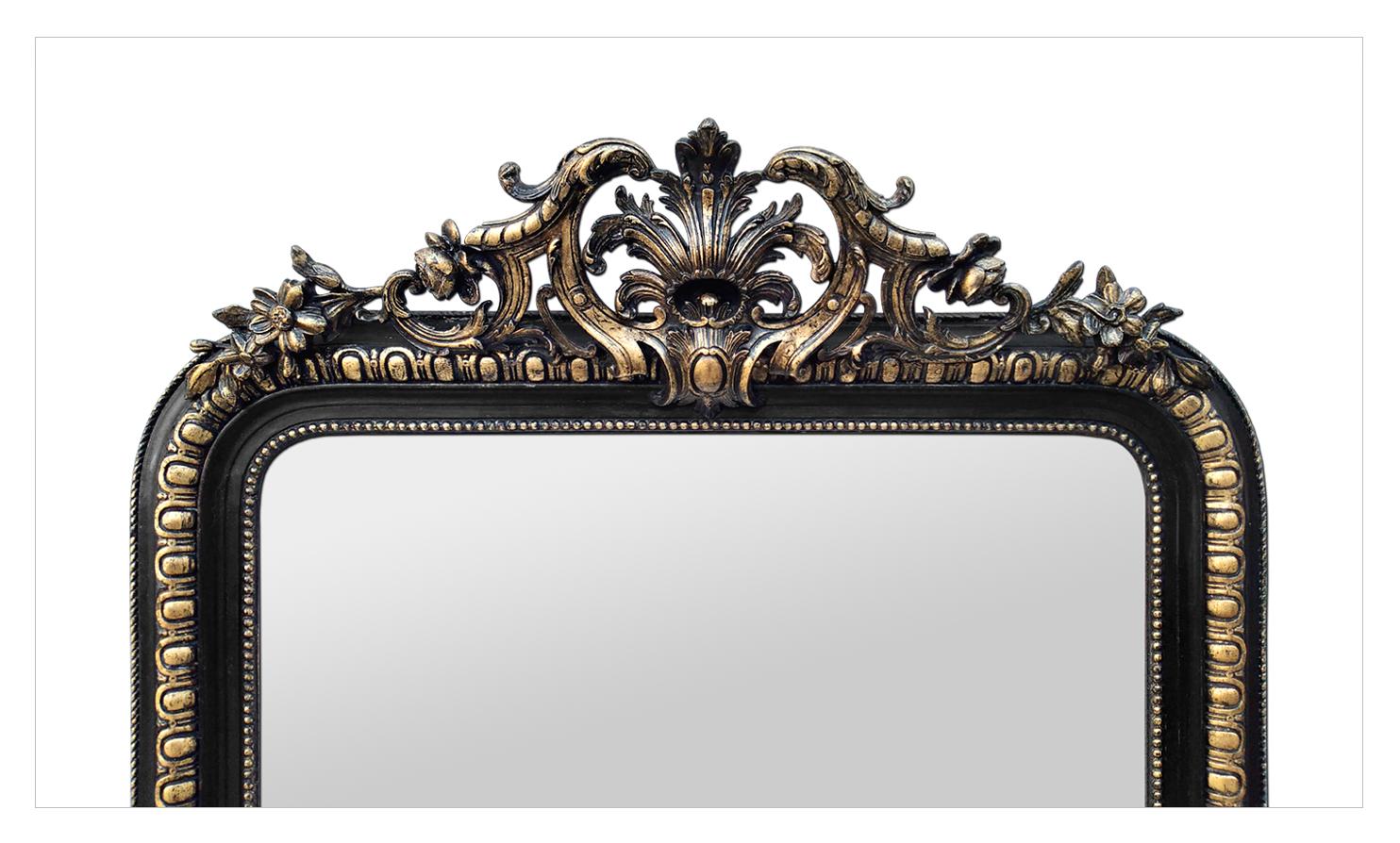 Large antique wall mirror with pediment, Napoleon III period, circa 1870. Antique pediment mirror, black and gilded, decor of stylized flowers and foliages, gadroons and pearls gilded on the frame. Re-gilding to the leaf patinated. Antique frame