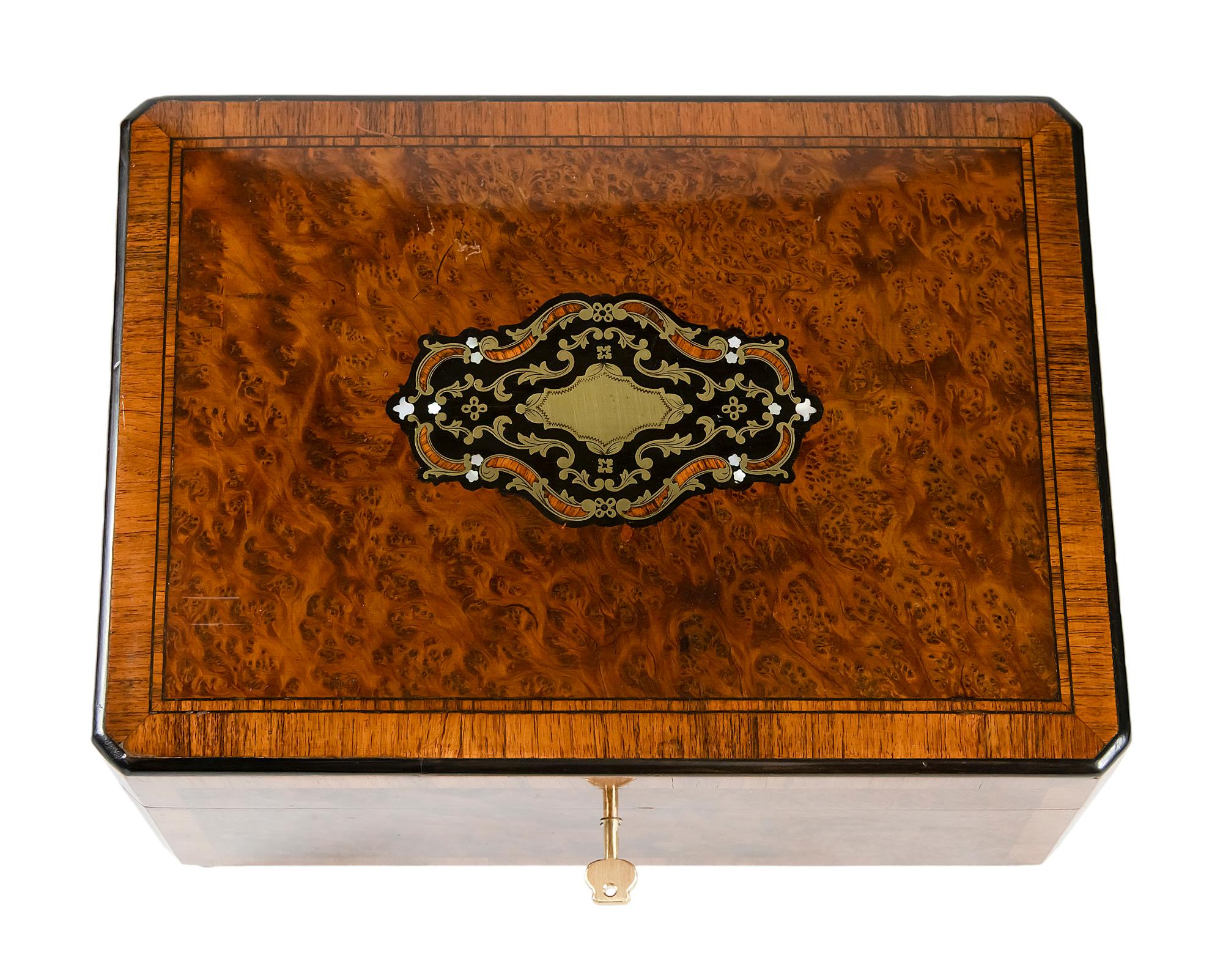 Antique 19th century French Napoleon III marquetry box.
The wallnut burl wooden box is decorated with inlaid brass and mother of pearl with the new brown colour velour textile on brass legs.
The key is included.

 
