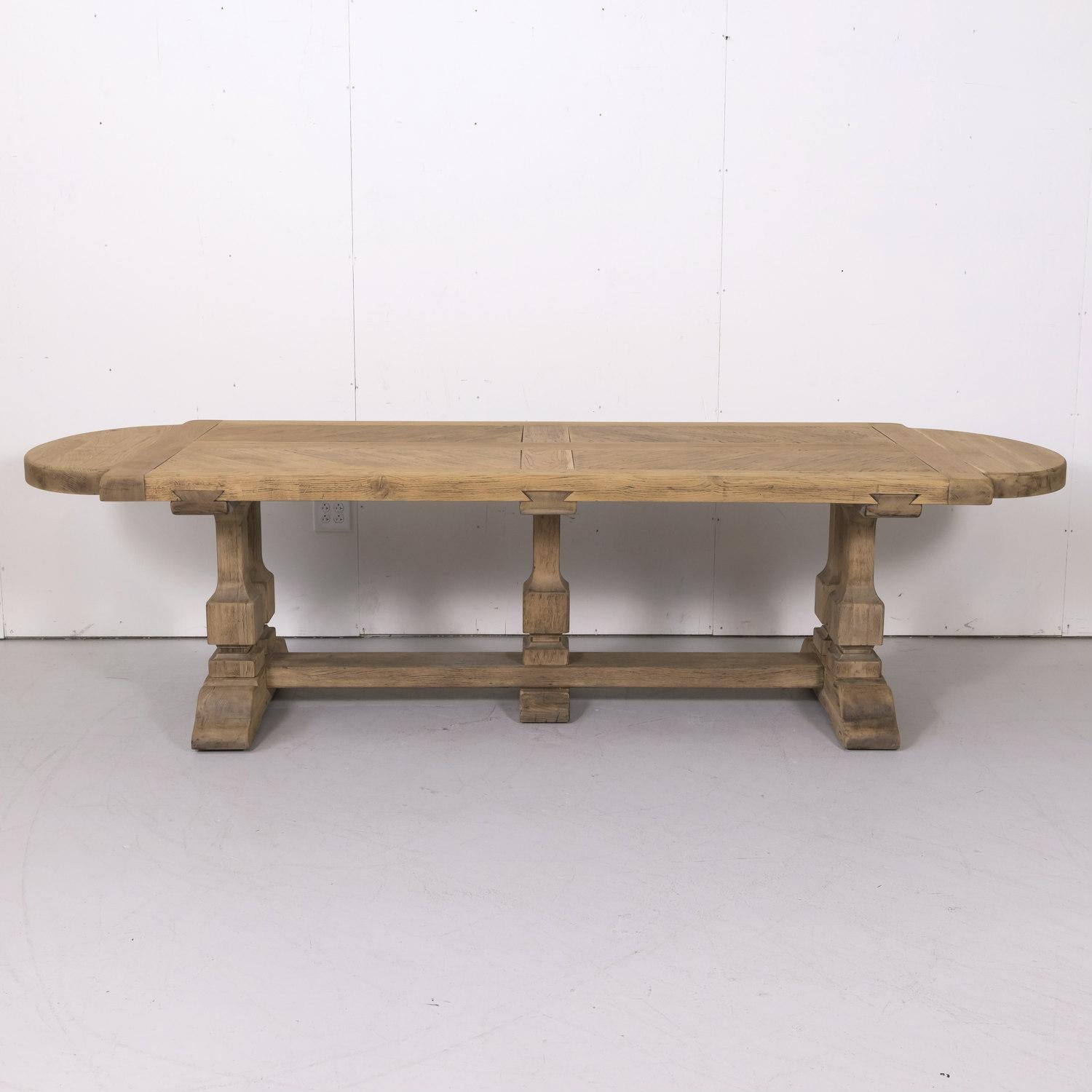 Large antique French monastery trestle table handcrafted by talented artisans near Caen, in the heart of Normandy, of old growth French oak bleached or washed to a natural finish and hand waxed to a beautiful patina, circa 1920s. Having a 2.75