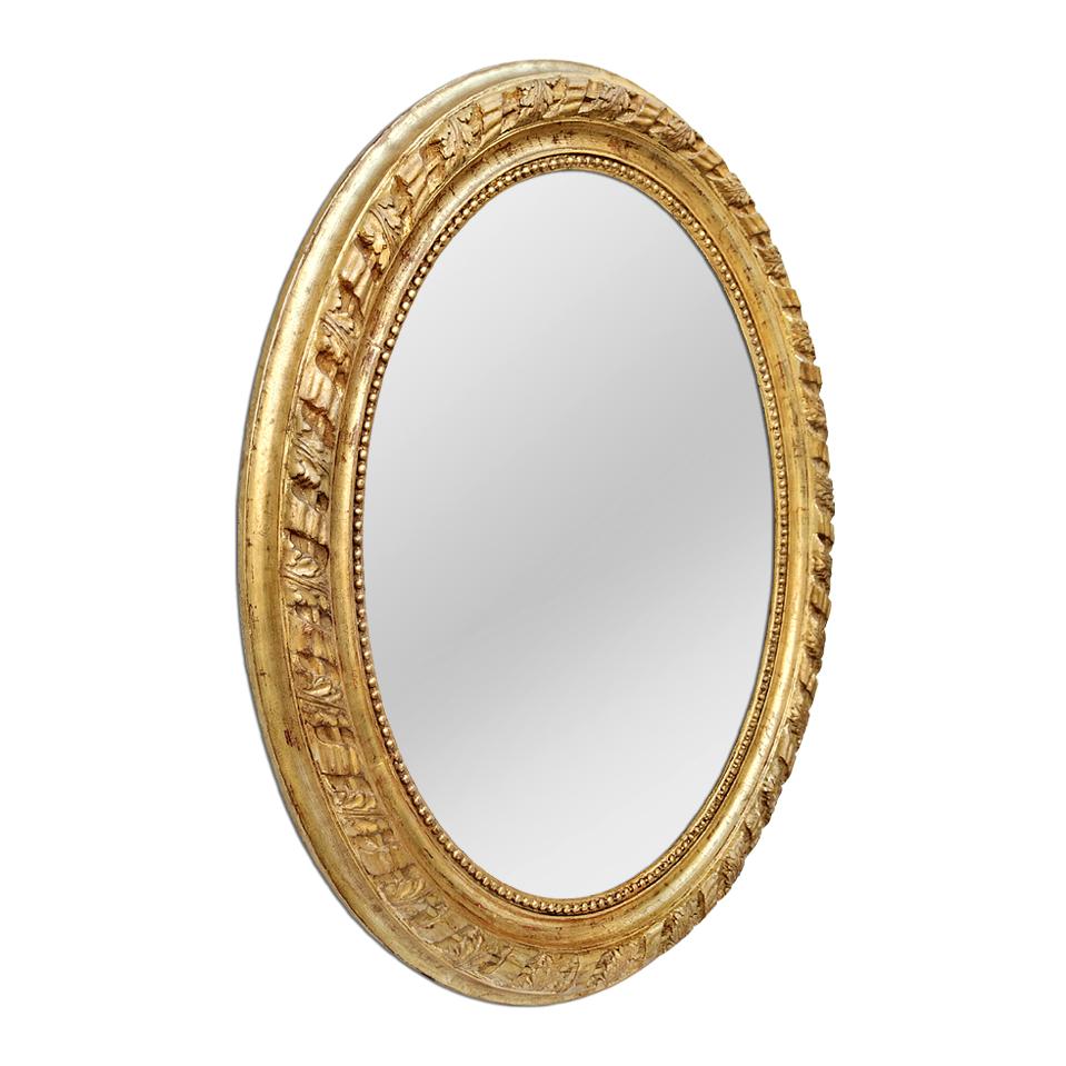 Large antique French oval giltwood mirror, Napoleon III style, circa 1860. Antique oval frame mirror decorated with large pearls on the edge of the glass and ribbons with acanthus leaves sculpted. Re-gilding to the leaf patinated. Antique frame