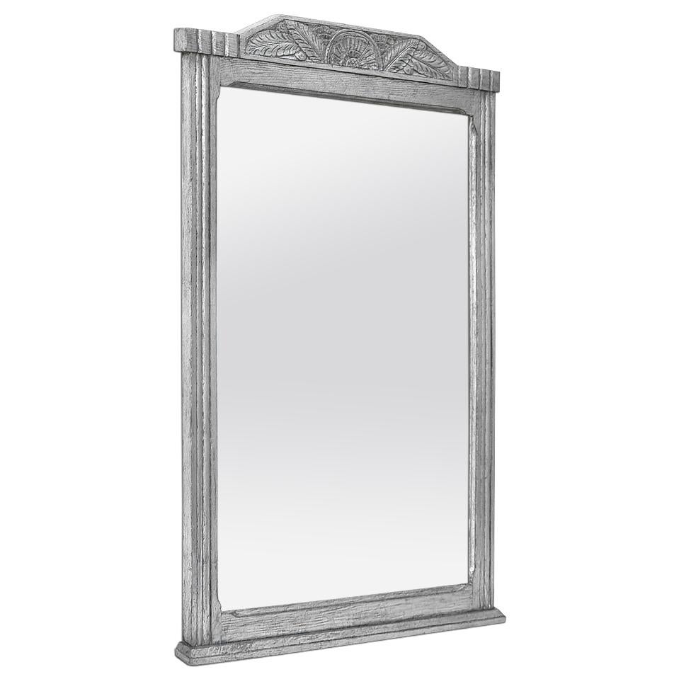 Large antique French silvered wood overmantel mirror, circa 1940. Antique frame carved oak wood with decoration stylized leaves and flowers on the pediment and grooves around the edge. Frame width: 6 cm / 2.36 in. Silvered with leaf. Modern glass