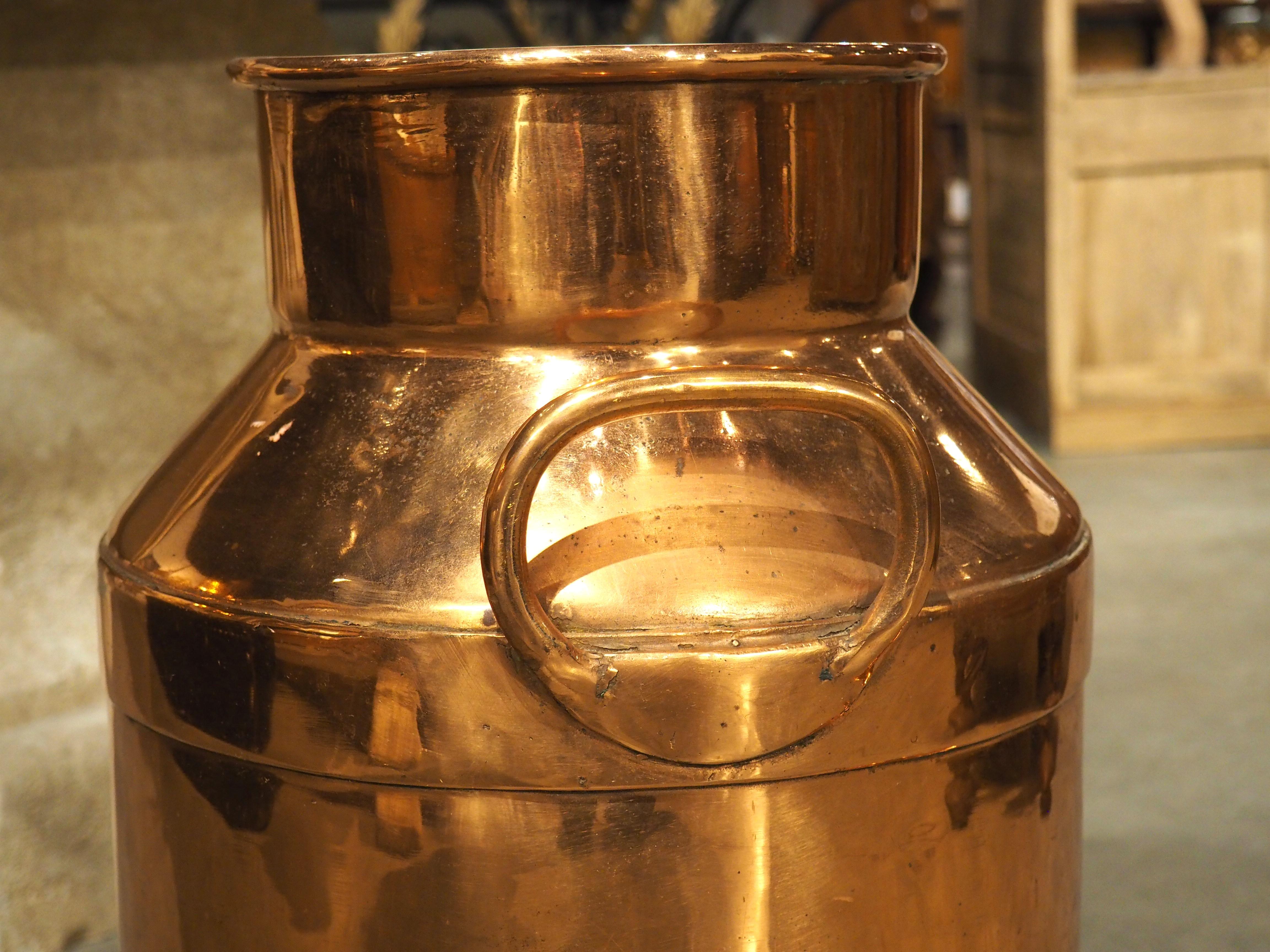 Measuring over 2 feet tall, this beautifully polished copper vessel is particularly large and dates to the early 1900s.  Before the advent of refrigerated trucks, metal milk containers, such as this would be used by dairy farmers to transport milk