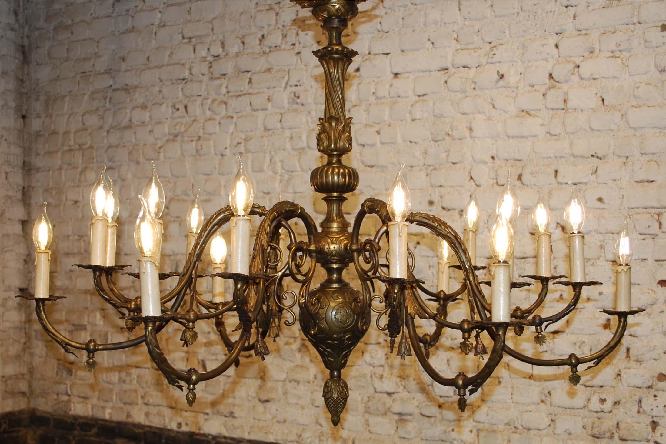 This impressive chandelier was made in France in the late 19th century. 
The chandelier has 6 arms each divided into three arms and has in total 18 bulbs. The piece is completely made in brass and it is decorated with many classic Renaissance