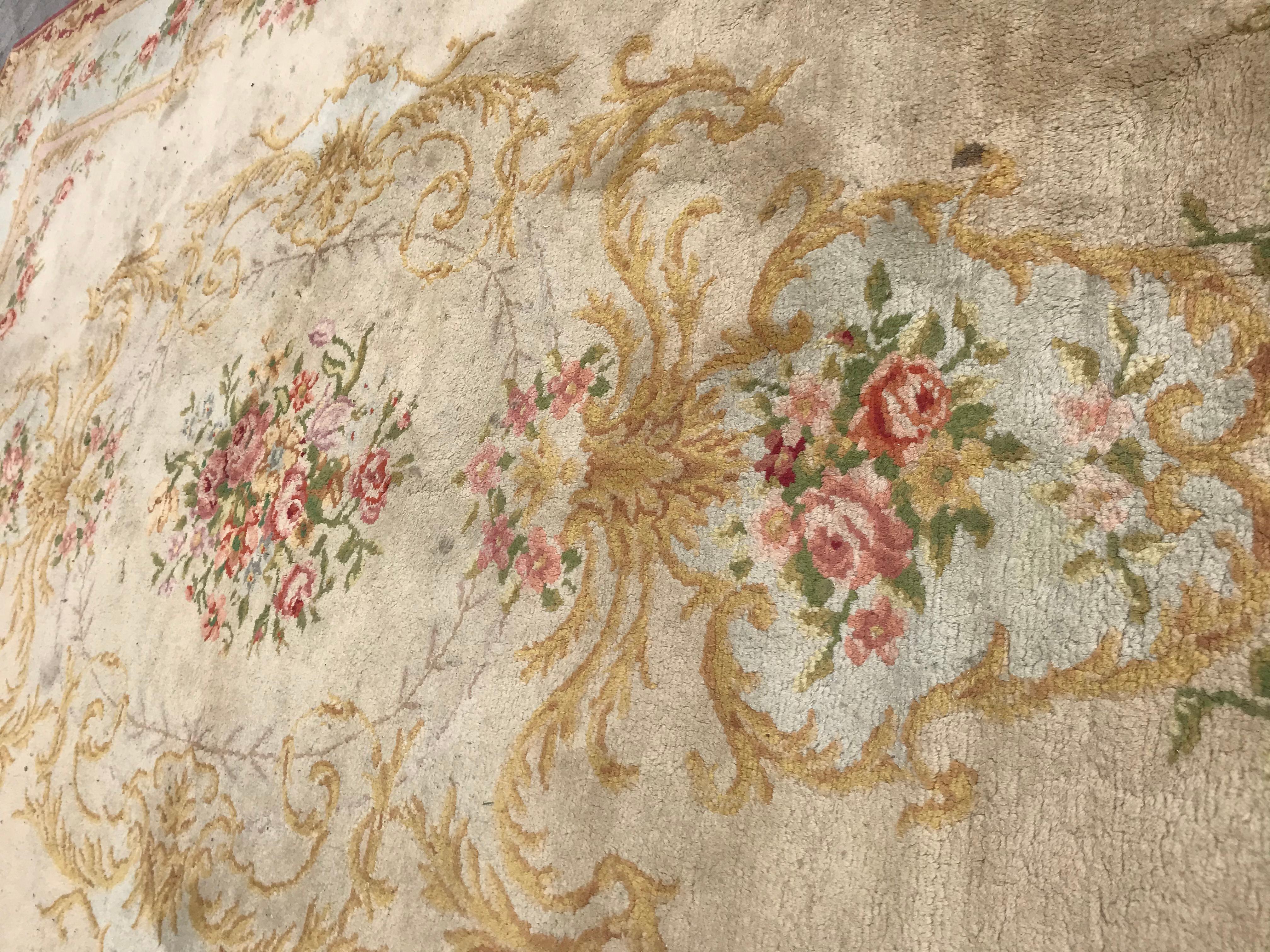 Very beautiful large antique Savonnerie French rug late 19th century Napoleon III, with beautiful floral design and light colors with beige, yellow, blue, green, orange, purple and pink, entirely hand knotted with wool velvet on cotton foundation.
