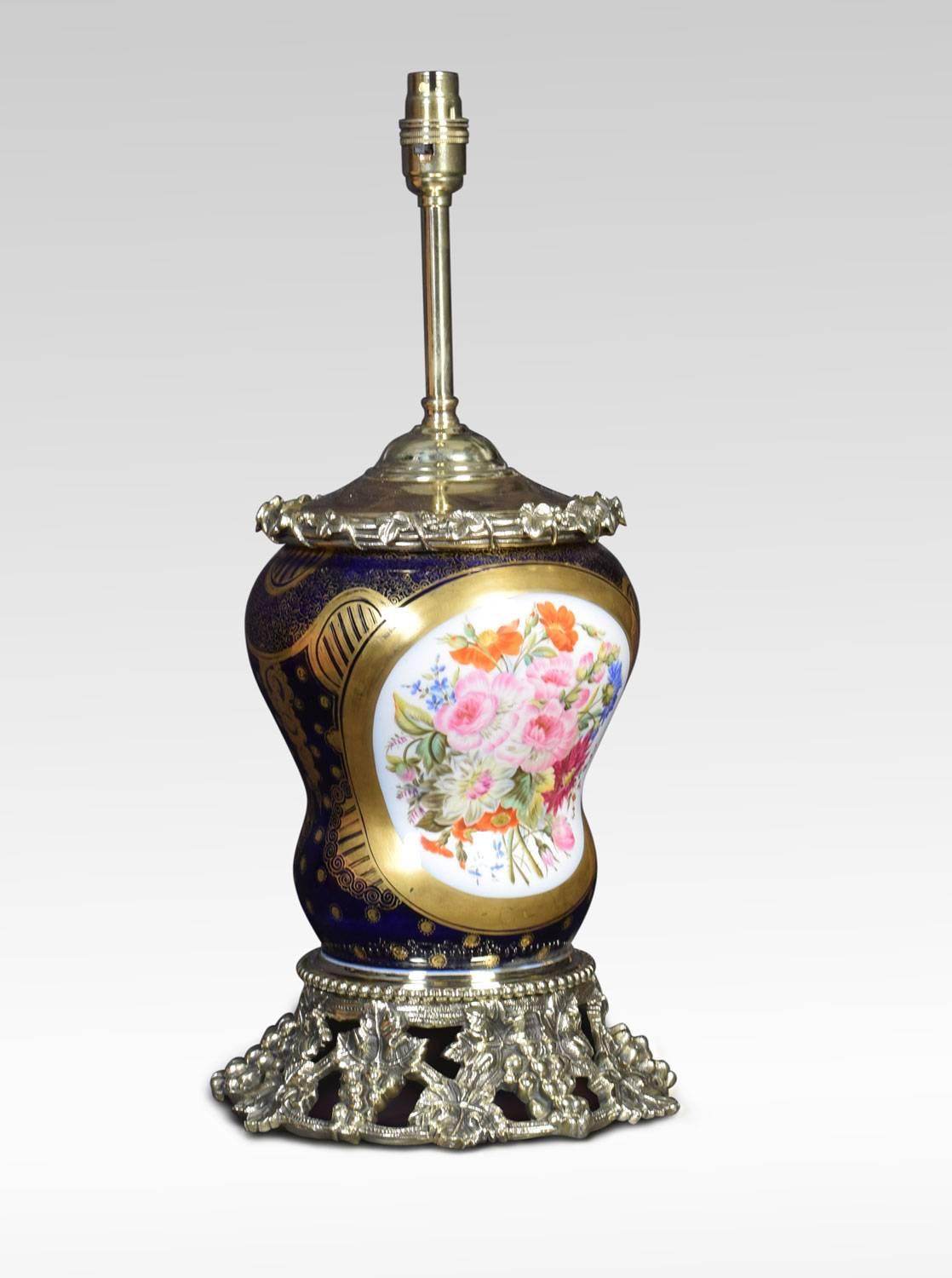 Sevres style table lamp, in cobalt blue with gold detail. The gilt bronze rim above central hand painted panel depicting maiden in typical dress the opposing side with floral motifs. Raised up on gilt bronze foliated base. (The lamp has been
