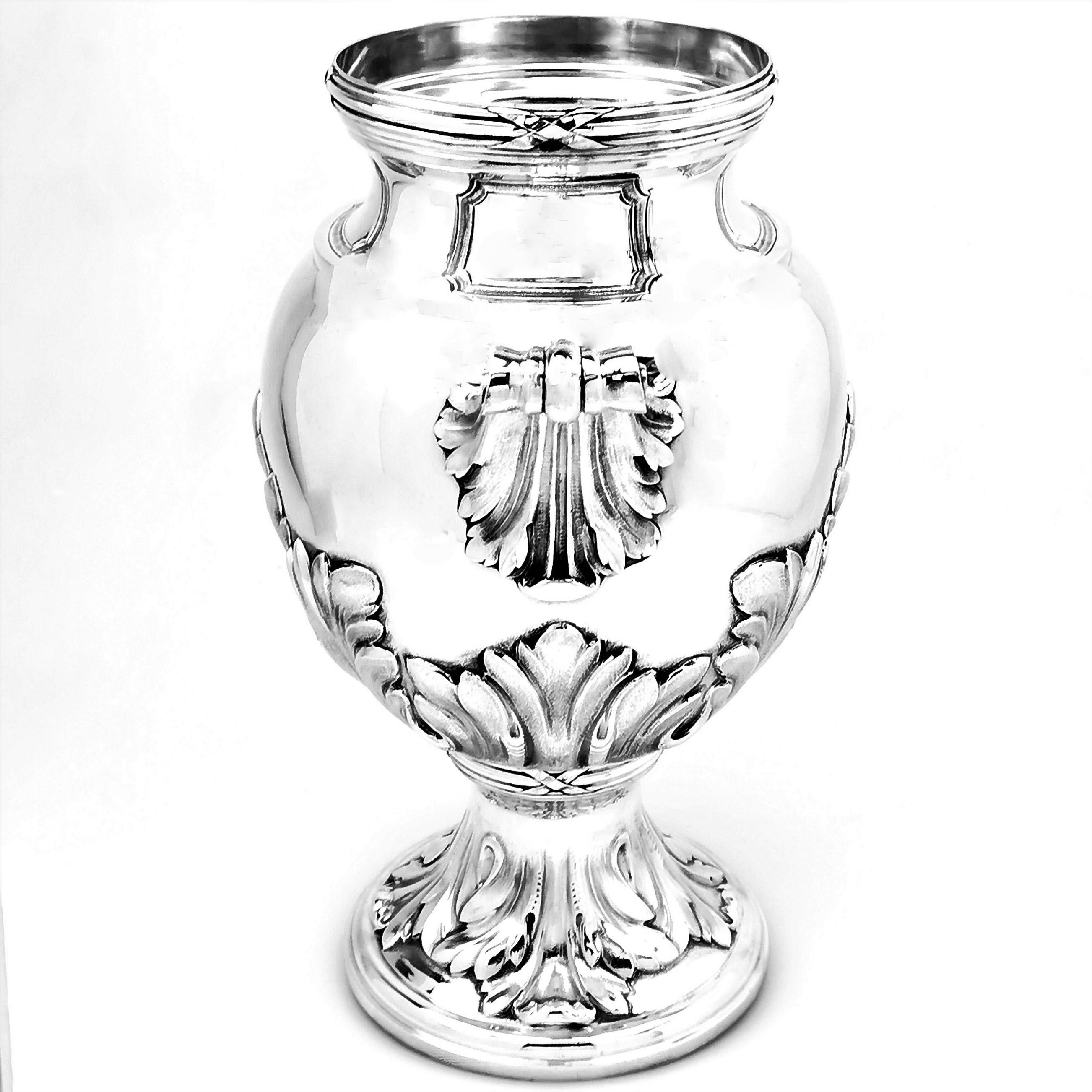 An impressive Antique French solid Silver Vase decorated with two substantial stylised leaf handles, The Body of the Vase and the spread foot are embellished with applied stylised leaves with a subtle matted finish against the polished body of the