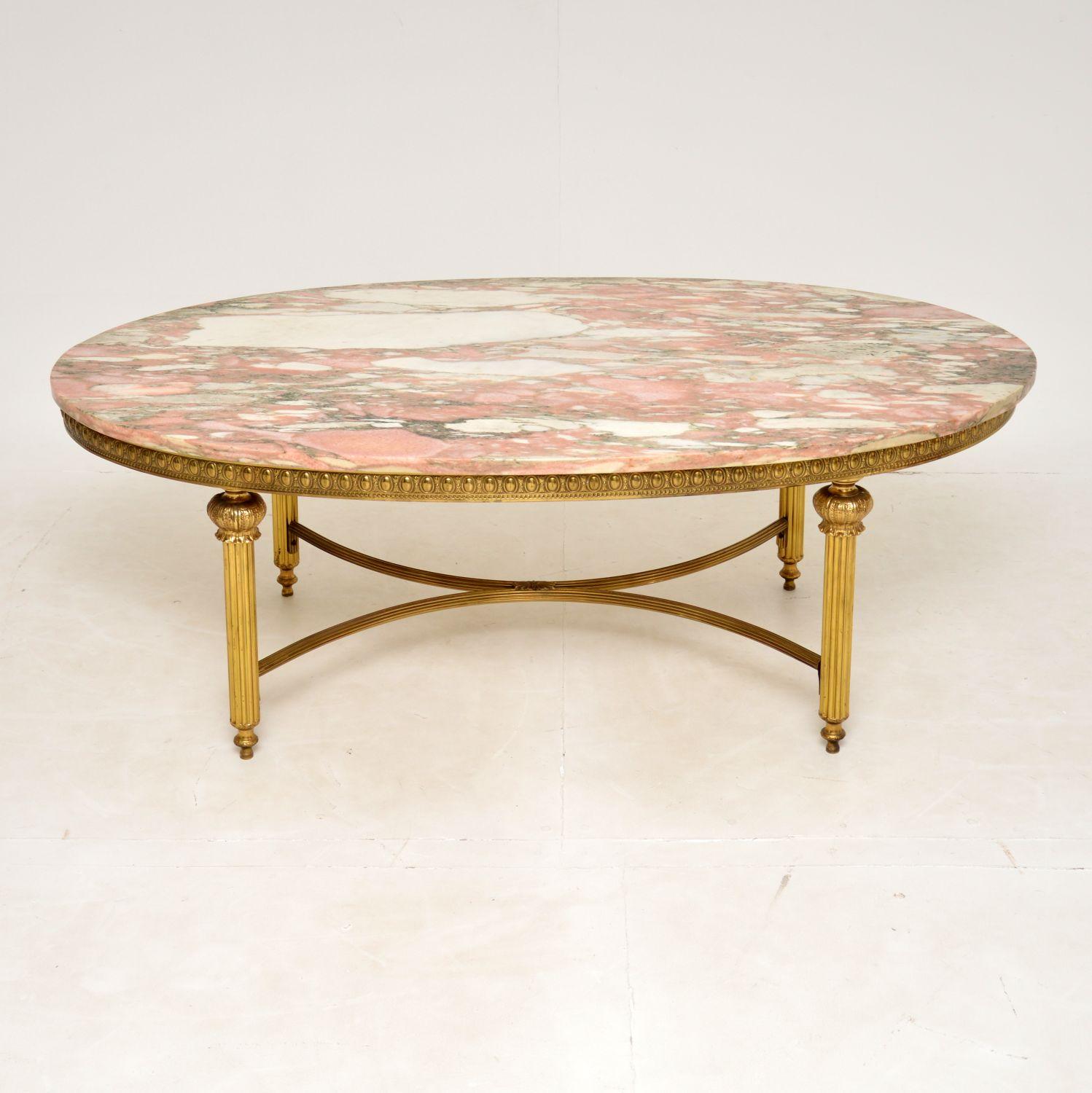 A very large and extremely impressive French style coffee table in solid brass and marble, dating from around the 1950’s period.
The quality is superb and the marble top is absolutely gorgeous. There are stunning colours and patterns, this is a