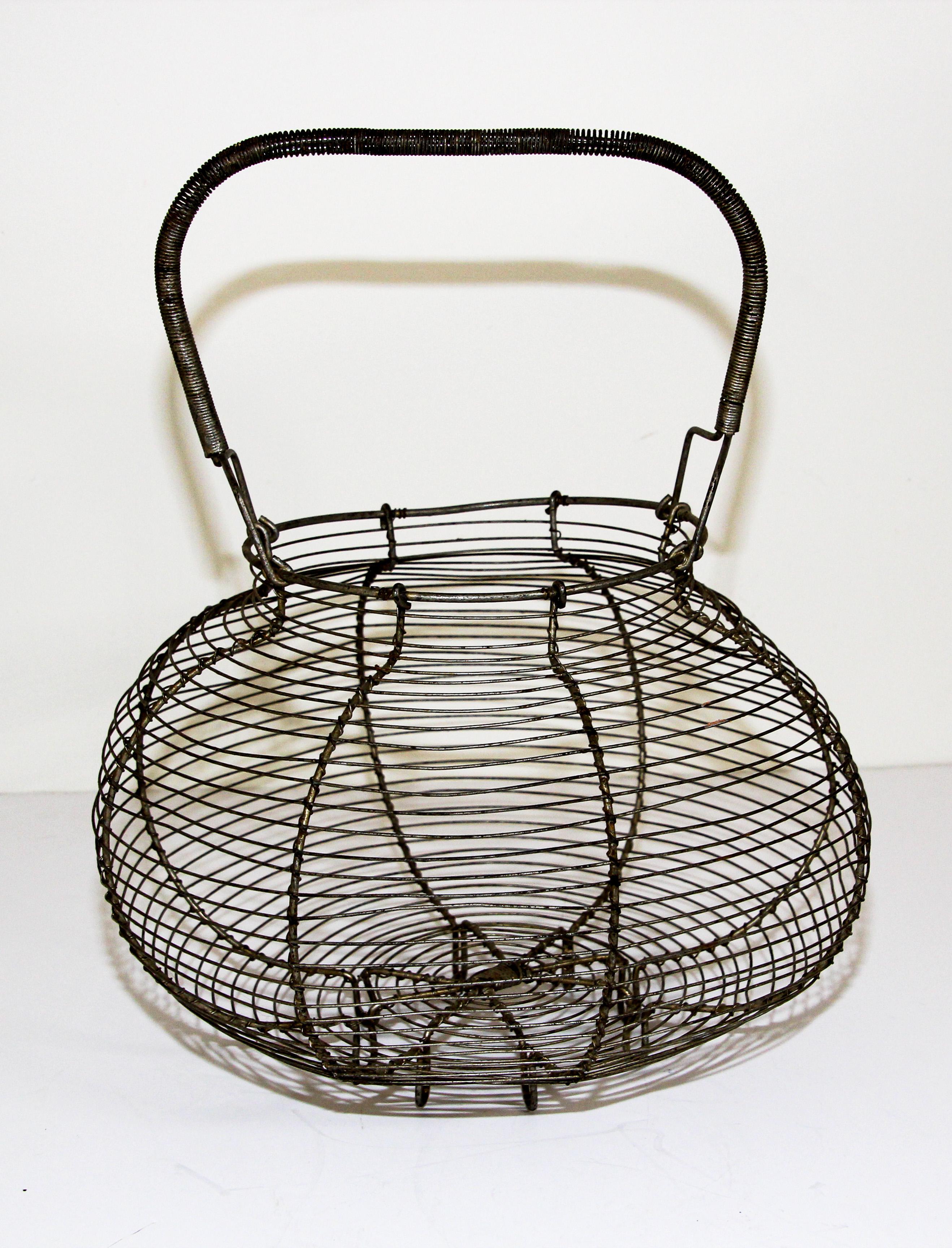 Antique French wire egg decorative basket with handle, circa 1940's.
This early little country rustic handle wire basket is in fine condition.
coiled handle, loop feet.
It is ideal for collecting eggs, gathering vegetables from the garden, or as a